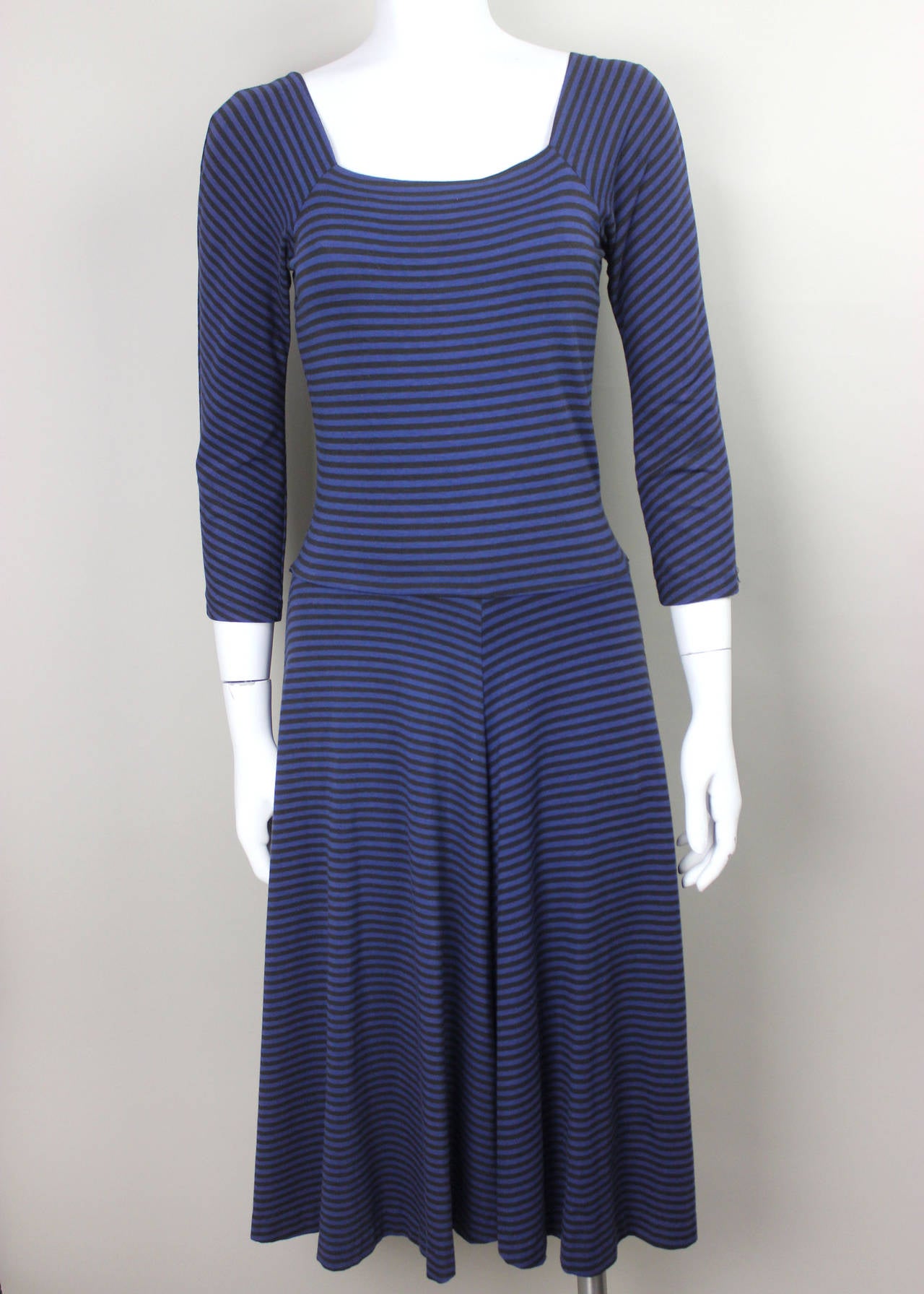 This classic Betsey Johnson late 80's dress is styled with a wide square neckline, fitted top, and long narrow sleeves. The skirt flares out from the waist and allows for lots of movement. The horizontal stripes give it a grunge fashion edge.