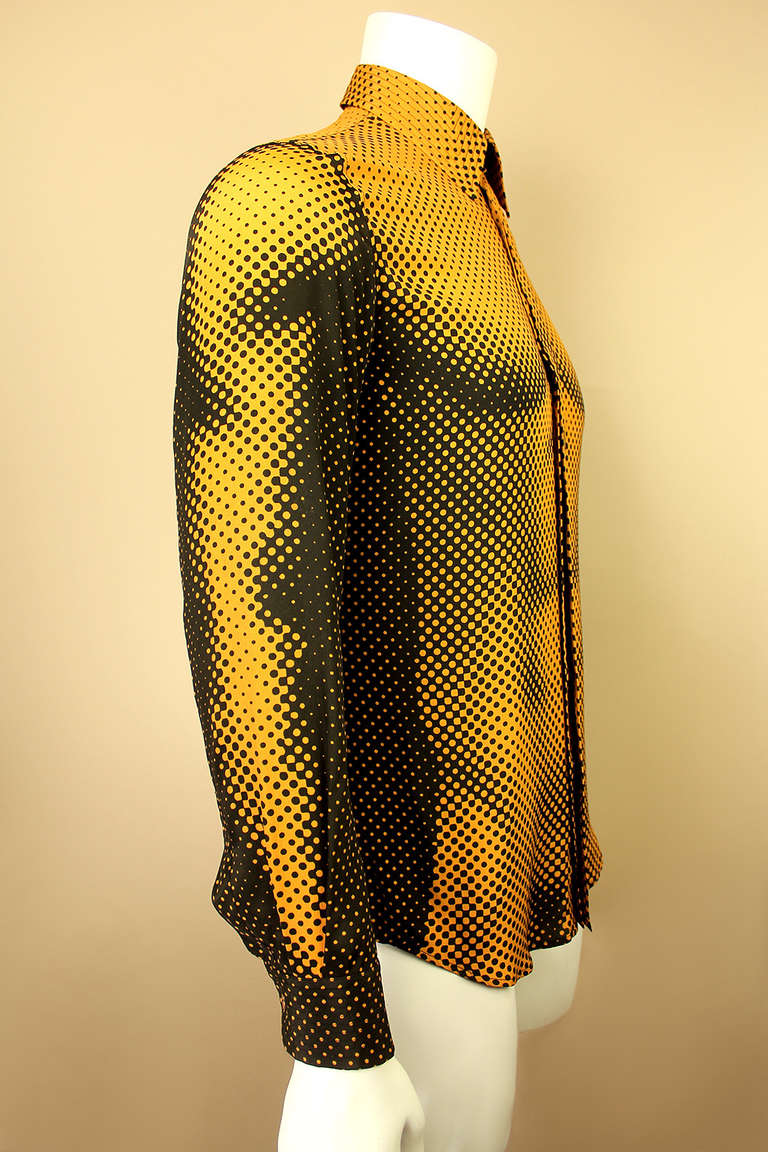 This Jean Paul Gaultier shirt features a photo print of a male torso front and back making it a very sexy garment. The colors are mustard and black, the fabric is a silk blend.