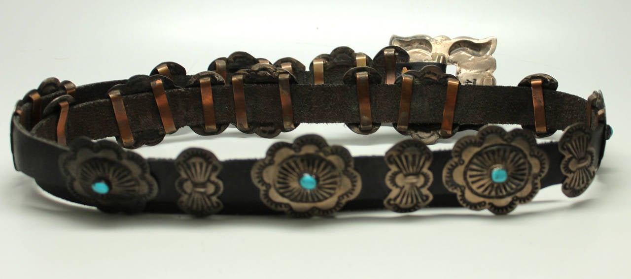 This is a rare Navajo belt by the artist Benson Yazzie, produced early in his career in the 1970's. His designs are very sought after by collectors of Navajo jewelry. This belt is outstanding in the large number of conchas it is decorated with.
