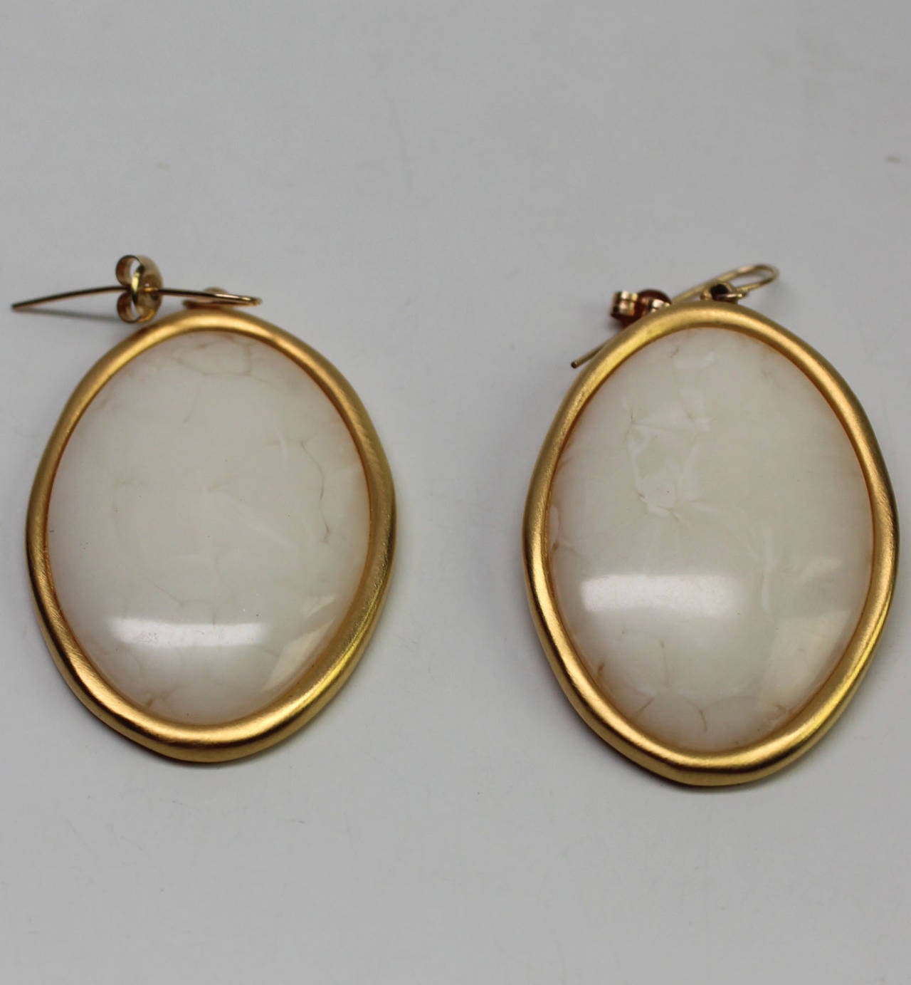 These stunning Givenchy earrings have a large opalescent stone in a gold frame hanging from a delicate wire post. These are the perfect summer earrings!