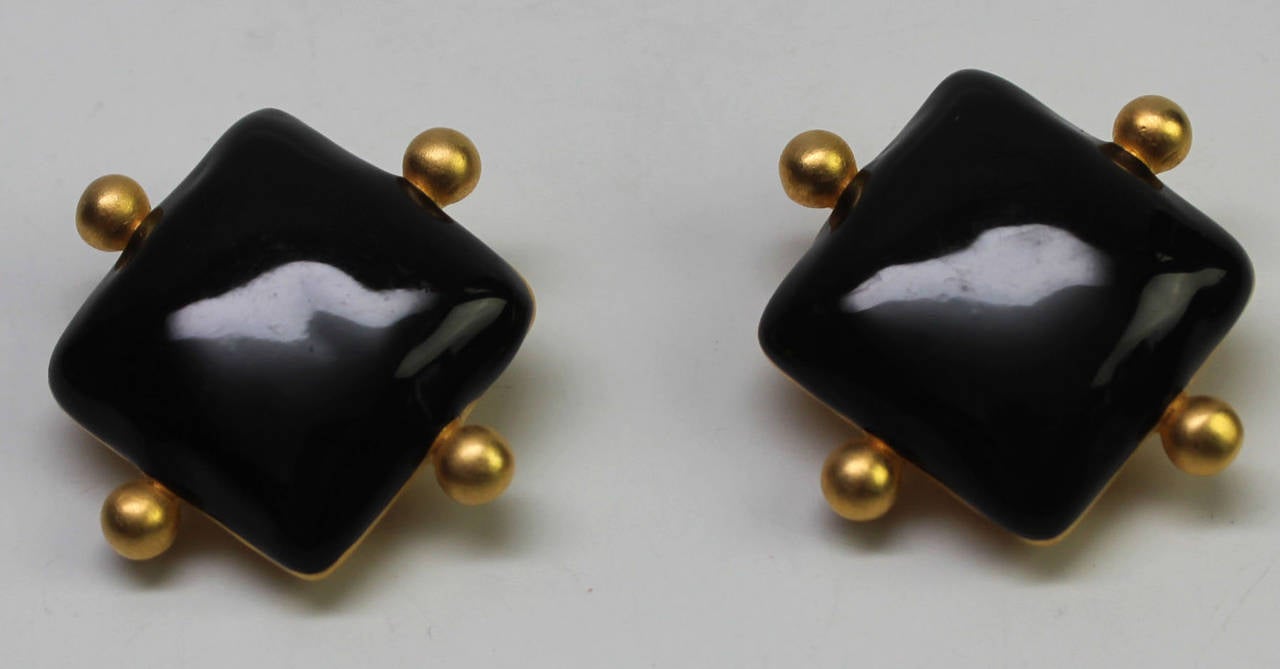 These bold clip earrings have a black diamond shaped center with four gold accents. The design is timeless and elegant. The Givenchy hallmark is stamped on back.