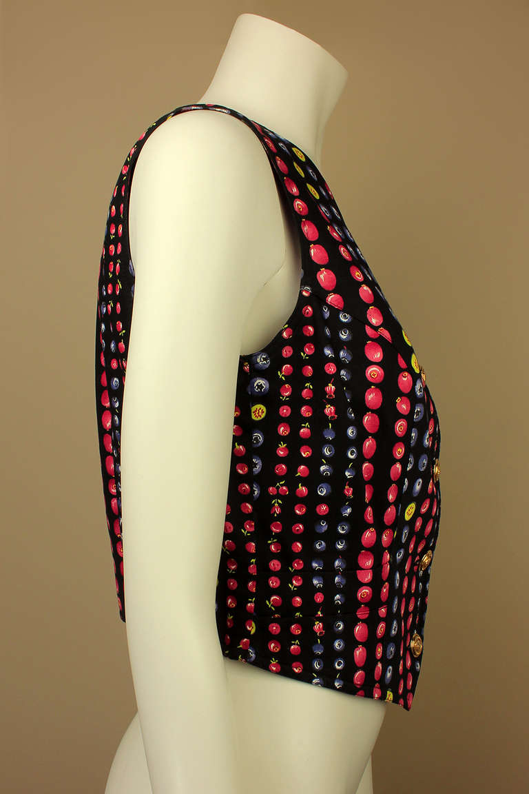 This vest has a fantastic and vibrant Versace photo print of assorted berries making it a fun and playful garment. It also has five signature gold Versace logo buttons as closures.
