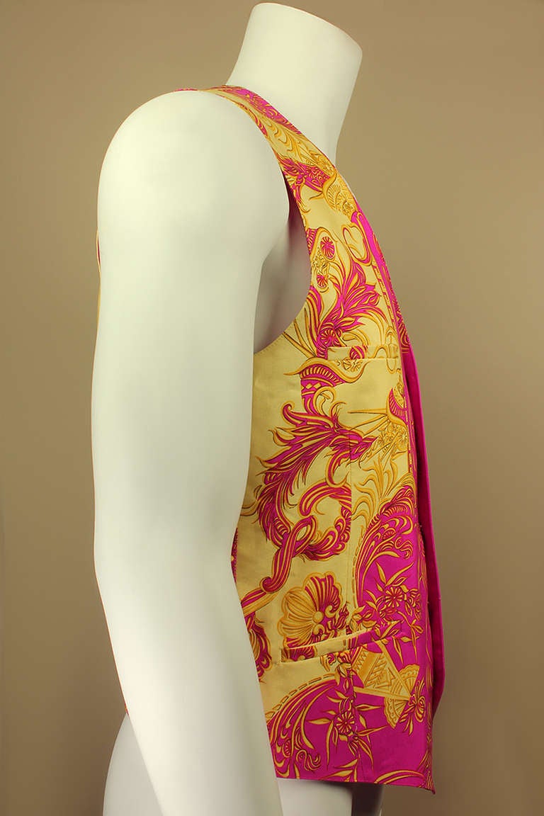 Gianni Versace was a master of extravagant baroque prints and this yellow and pink beauty is a perfect example. This is a classic men's vest style in an iconic Versace print.