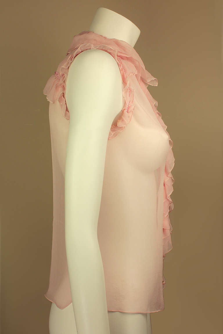 This beautiful pale pink blouse is made of the softest silk chiffon with flirty ruffles at the neck, front, and sleeves.