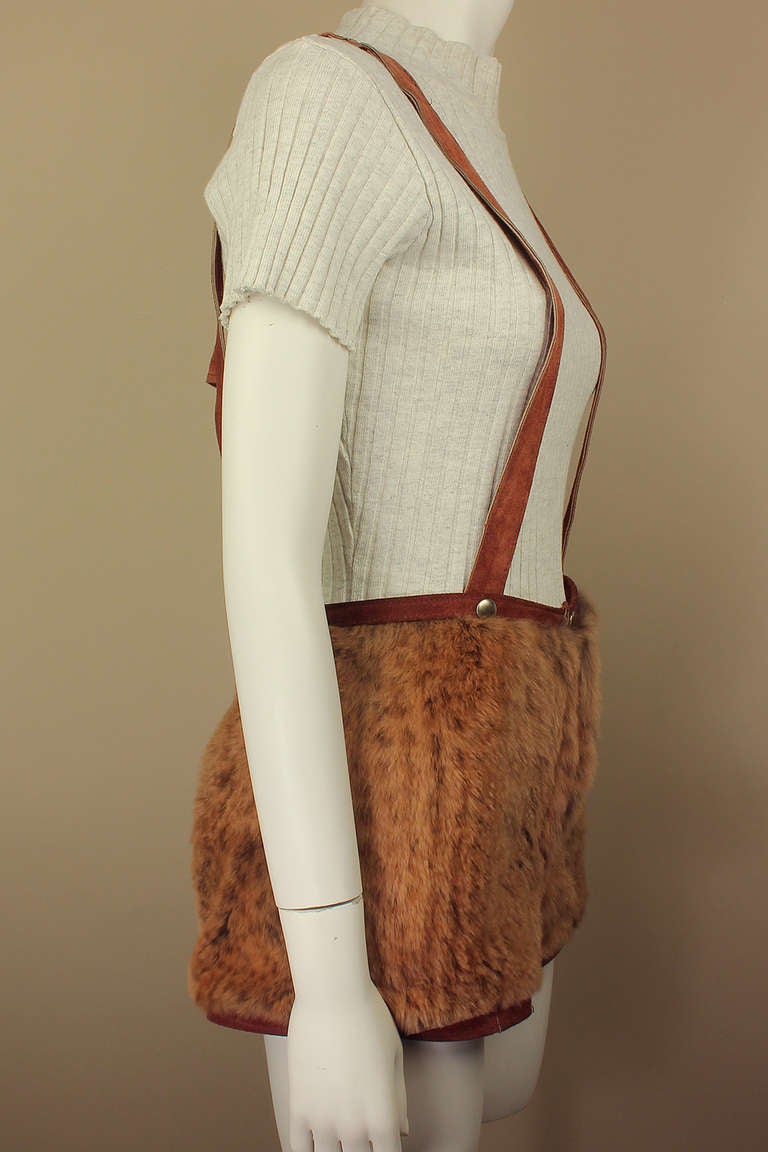 These amazing fur shorts were designed by Margaret Godfrey for Bagatelle in the 1980s. There is no labeling for the fur type but it is incredibly soft & subtle in a lush caramel/brown. The shorts are trimmed in rust suede with matching snap-on