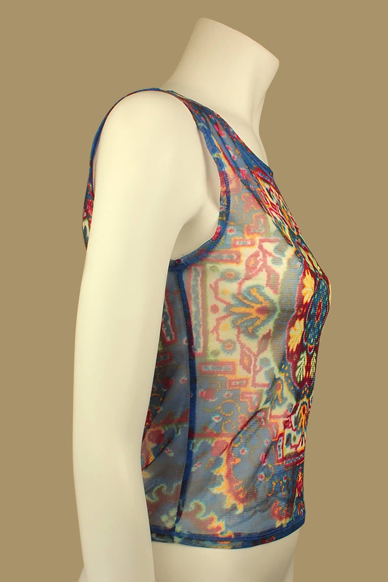 This Todd Oldham sheer sleeveless tee has a beautiful, cool, bold, and symmetrical pattern printed on it. This tee is of the TO2 line, one that was launched allowing his clothing to be accessible to juniors.