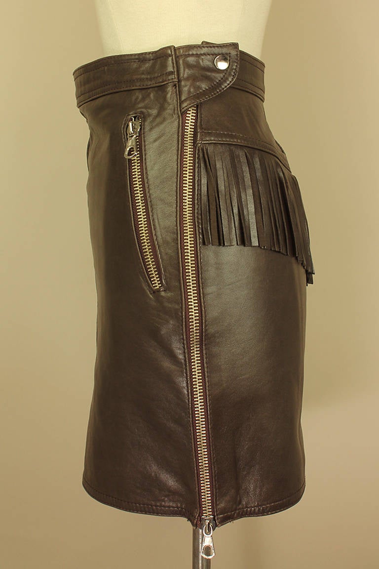 Fringe and zippers are the height of fashion right now & this vintage skirt is a great way to wear it. It's made of soft brown leather and is 16 inches long, a perfect above the knee length skirt with zip open sides and pockets.