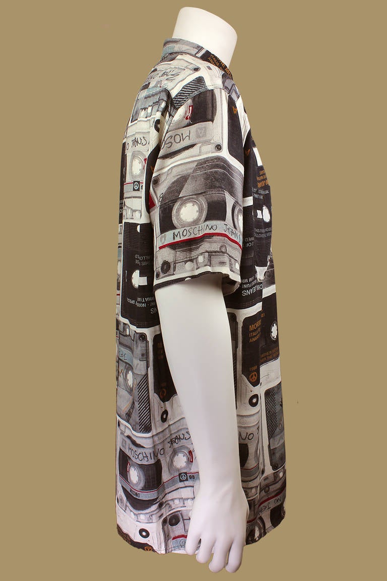 This shirt is emblazoned with Moschino witticisms. The all over print is of various cassette mix-tapes with names and titles of imagined Moschino Jeans songs: Pizza, Yin and Yang, Love Nature! An overall unique print; perfect for anyone in the music