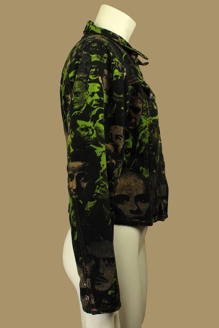 There is great detailing and patterns in this denim jacket. A back buckle gives it a nipped-in, cropped silhouette. The pattern is a collage of faces in greens and rusts almost giving it the look of camoflauge.