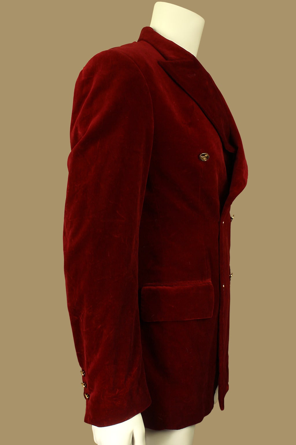 This is the perfect jacket to wear to a holiday party. It is double-breasted with signature gold Vivienne Westwood buttons down the front and on the sleeves. It is in a sumptuous dark red velvet.