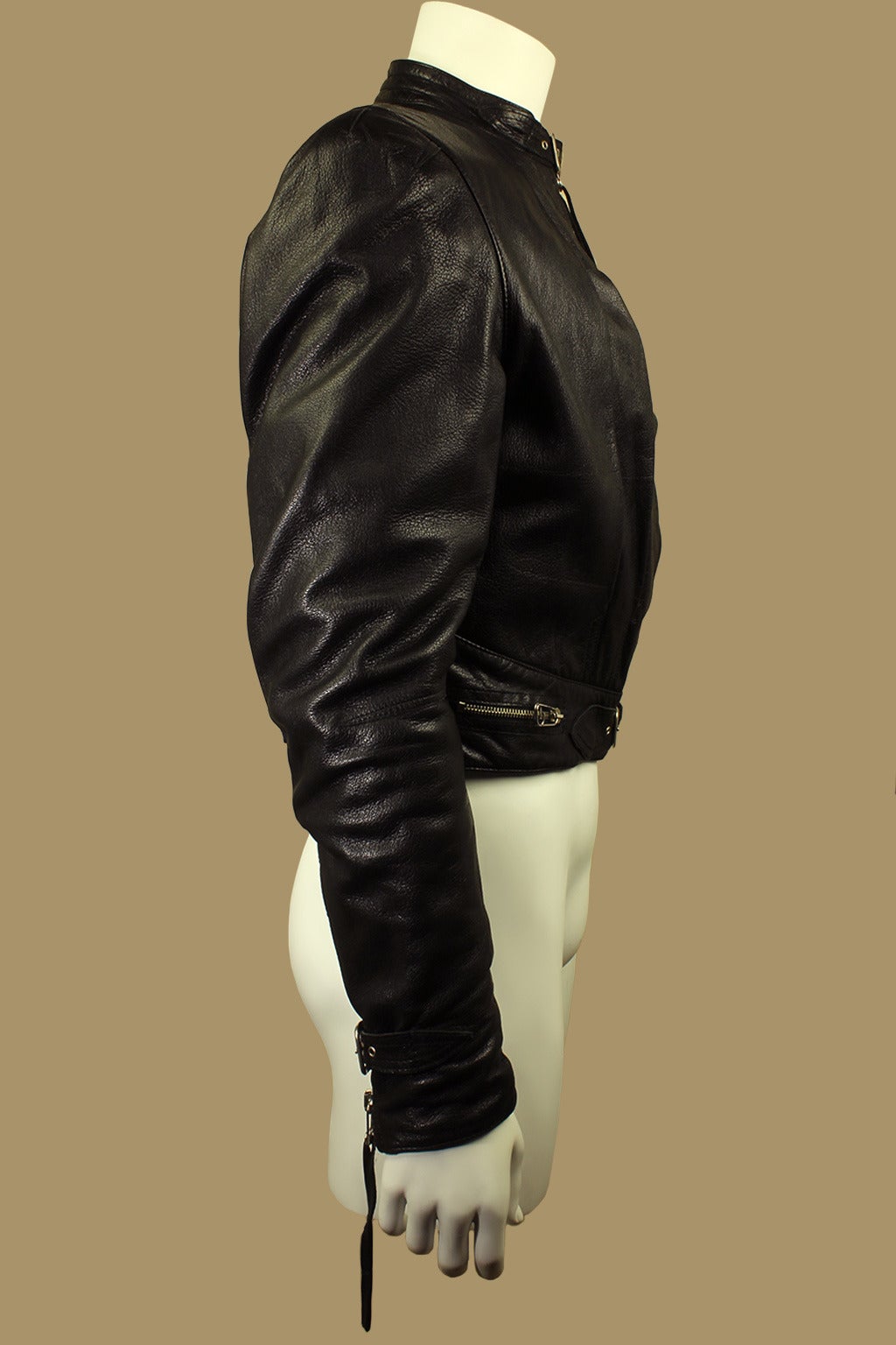 There are incredible details in the design of this motorcycle jacket. There are functional buckles at the high neck and waist. The body has three flat pleats adorning the front plus two low slash zippered pockets. The sleeves have a tasseled zipper