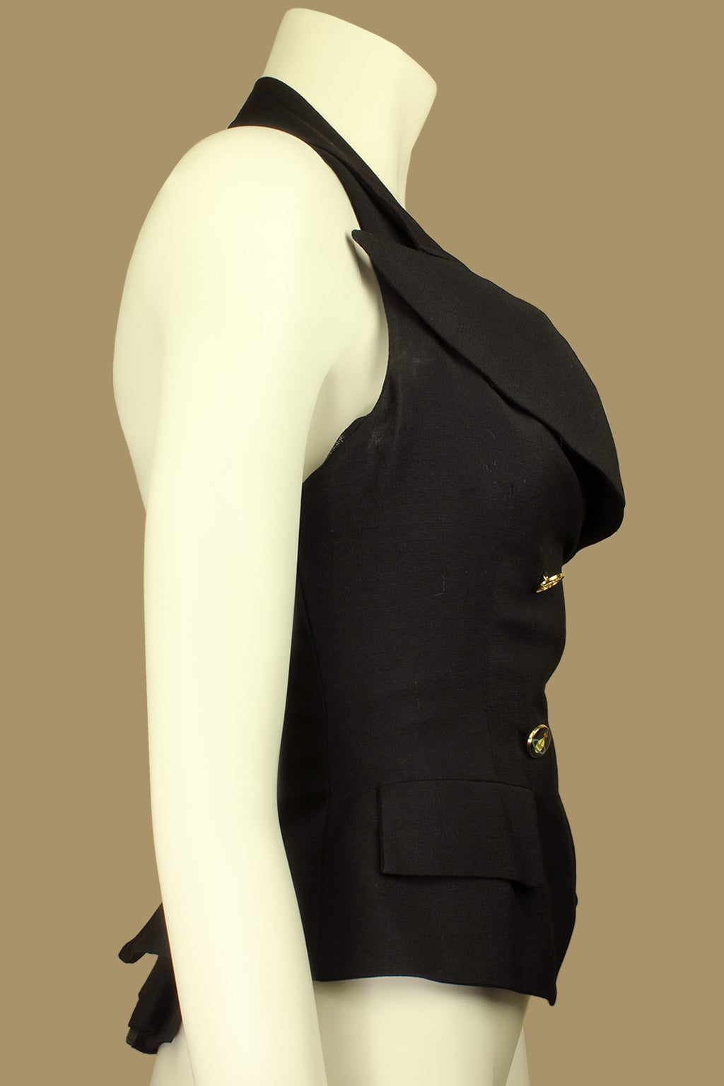 This flattering top has an intricate design. A zip front boned corset has a wool overlay attached with a halter neck, shawl collar, signature orb buttons, and two slash pockets. The back has a pleated peplum. It has a sexy, form fitting silhouette.