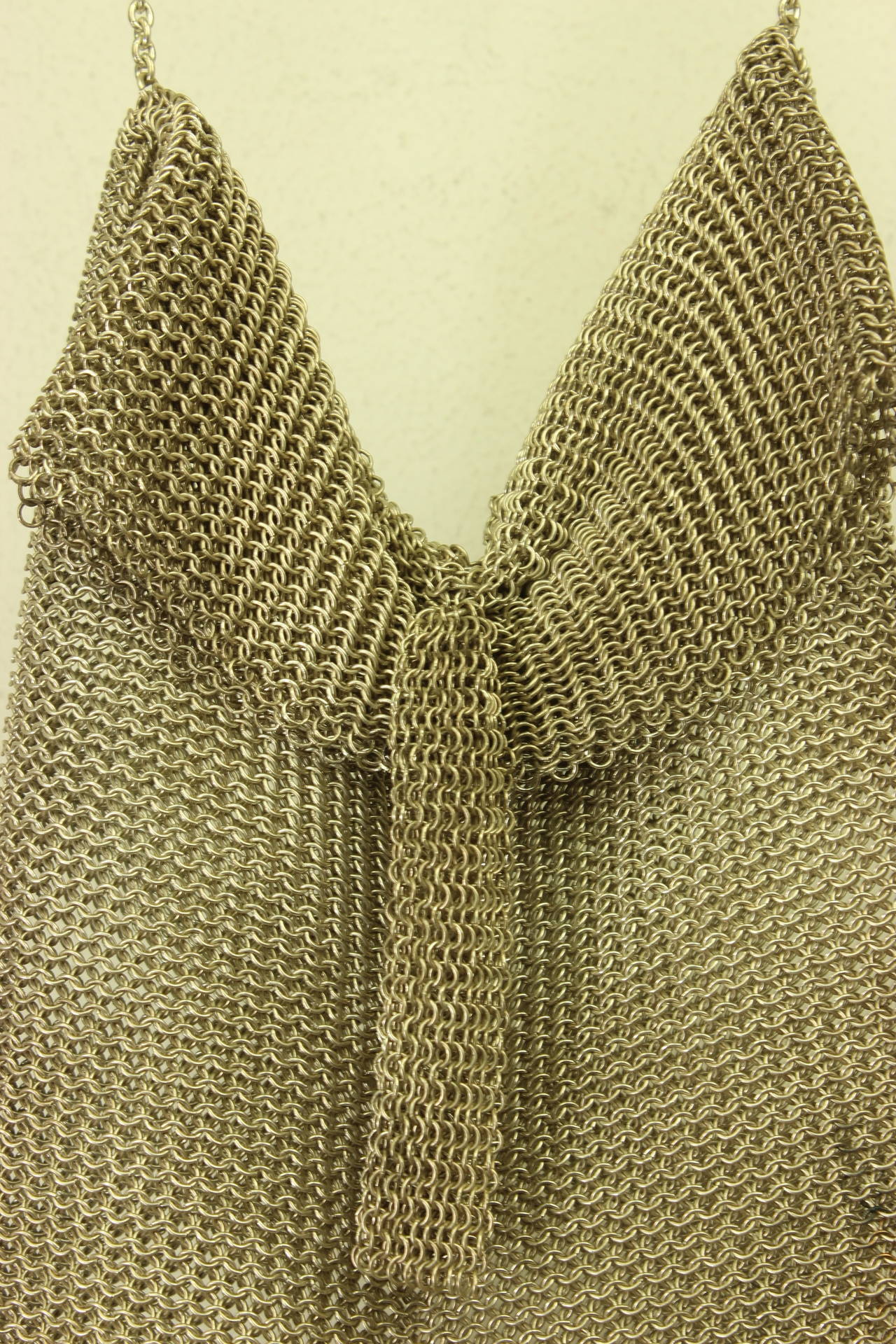 Metal mesh purses were a popular 1920’s item. This one has unusual features with a fold over top and attached tassel. It was designed as a shoulder bag with a long chain which is unique.