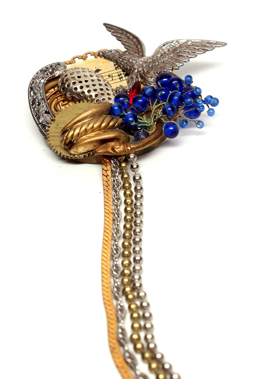 Patriotic and whimsical, these eclectic collage inspired pins are connected by four elegantly draped chains of mixed metals. This Maximal Art double pin is perfect for a creative, individual fashion statement or unique gift. Maximal Art was one of