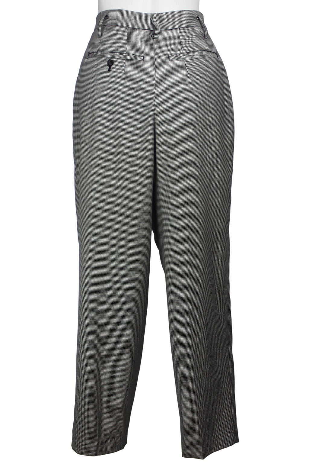 SALE! Originally $450
These high waisted wool houndstooth trousers with a double pleat reference classic masculine lines. With slanted pockets in front and slit pockets in back, they are slightly cropped and narrow at the bottom hem.