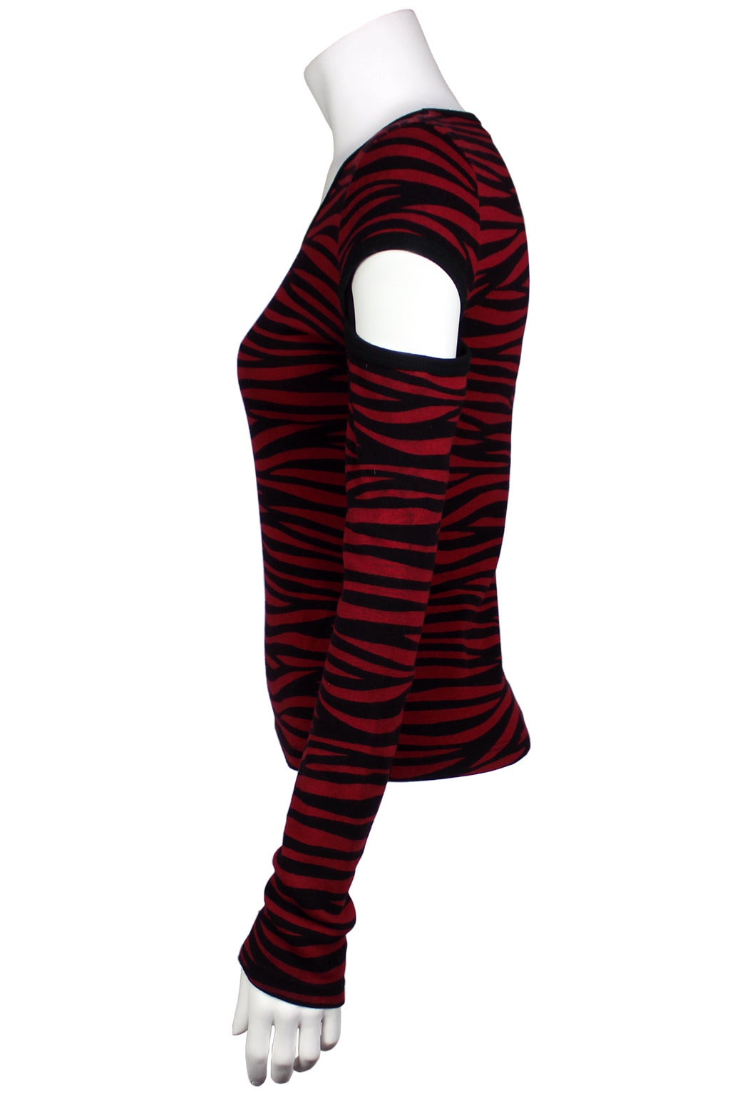 This wine and black tiger striped tee is a great example of a Sonia Rykiel novelty knit. The long sleeves have shoulder cutouts and exposed seams. The body is fitted and hip length.