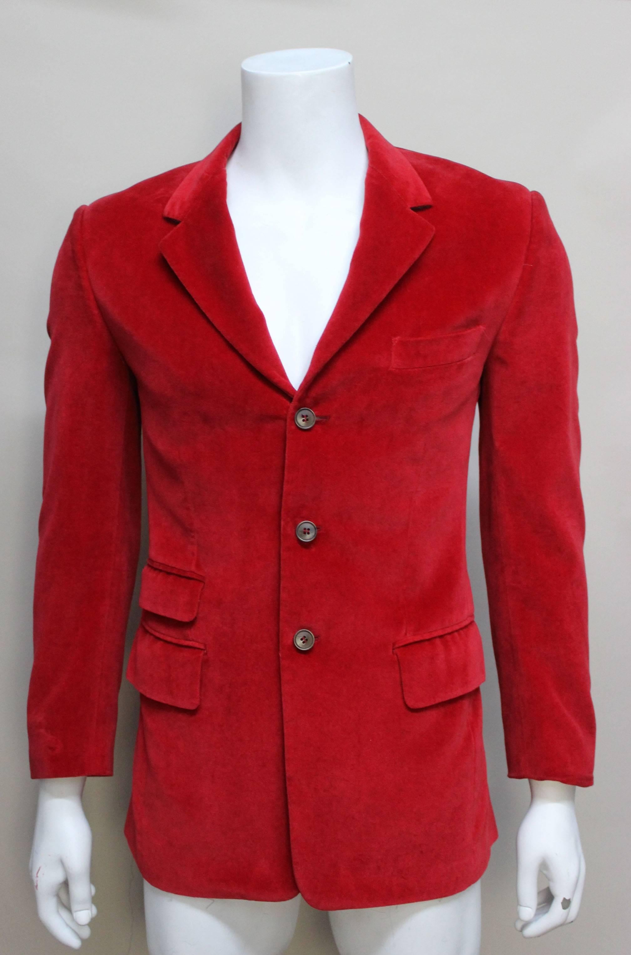 This classic three button jacket is perfect for the holiday season. The cut is a slim fit, has two back vents and three front pockets with flaps and a breast pocket. The rich red color and luxe velvet fabric makes this a perfect formal addition to
