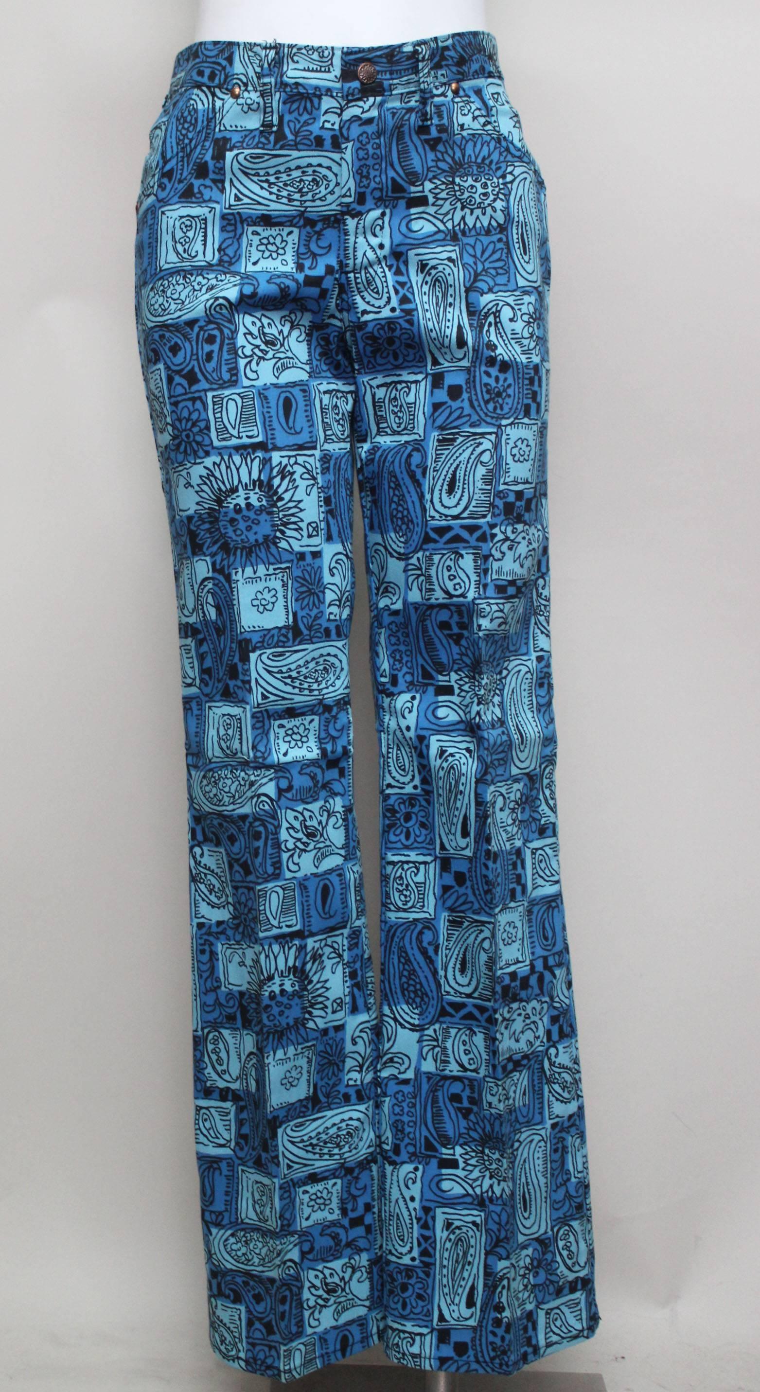 SALE! Originally $285
This is a pair of never worn cotton flares with a vibrant colored print. Paisley patterns are entwined within geometric shapes in a turquoise and cerulean blue. They have a jean cut top extending into a perfect flare bottom.