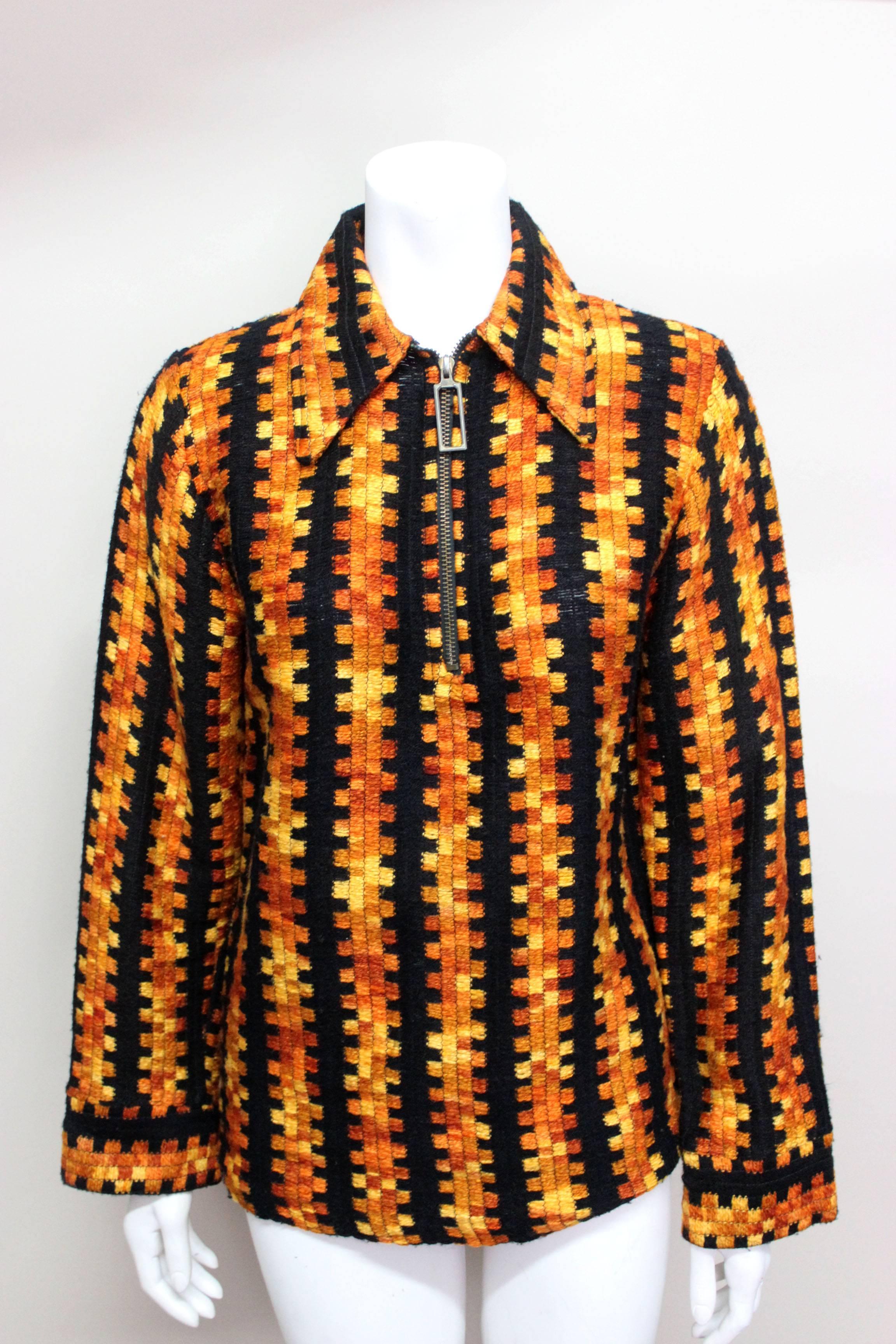 This 1970's knit is an exceptional piece. The ombre woven fabric is in a very unusual geometric pattern. The zippered front with long brass zipper pull is a quintessential 1970's style detail. 