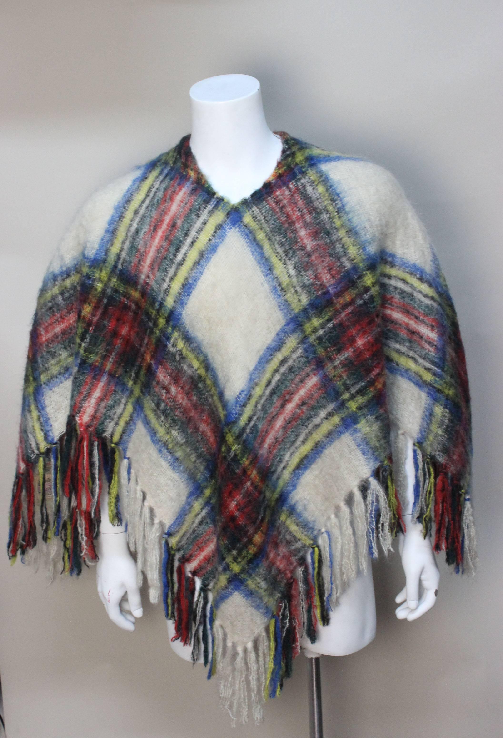 Glentana Mills in Scotland were producing woolens from as far back as the 1870's. This is a fine example of what was produced in the 1960's. This poncho is of high grade mohair in a pleasing muted plaid with generous tassels along its hem. 