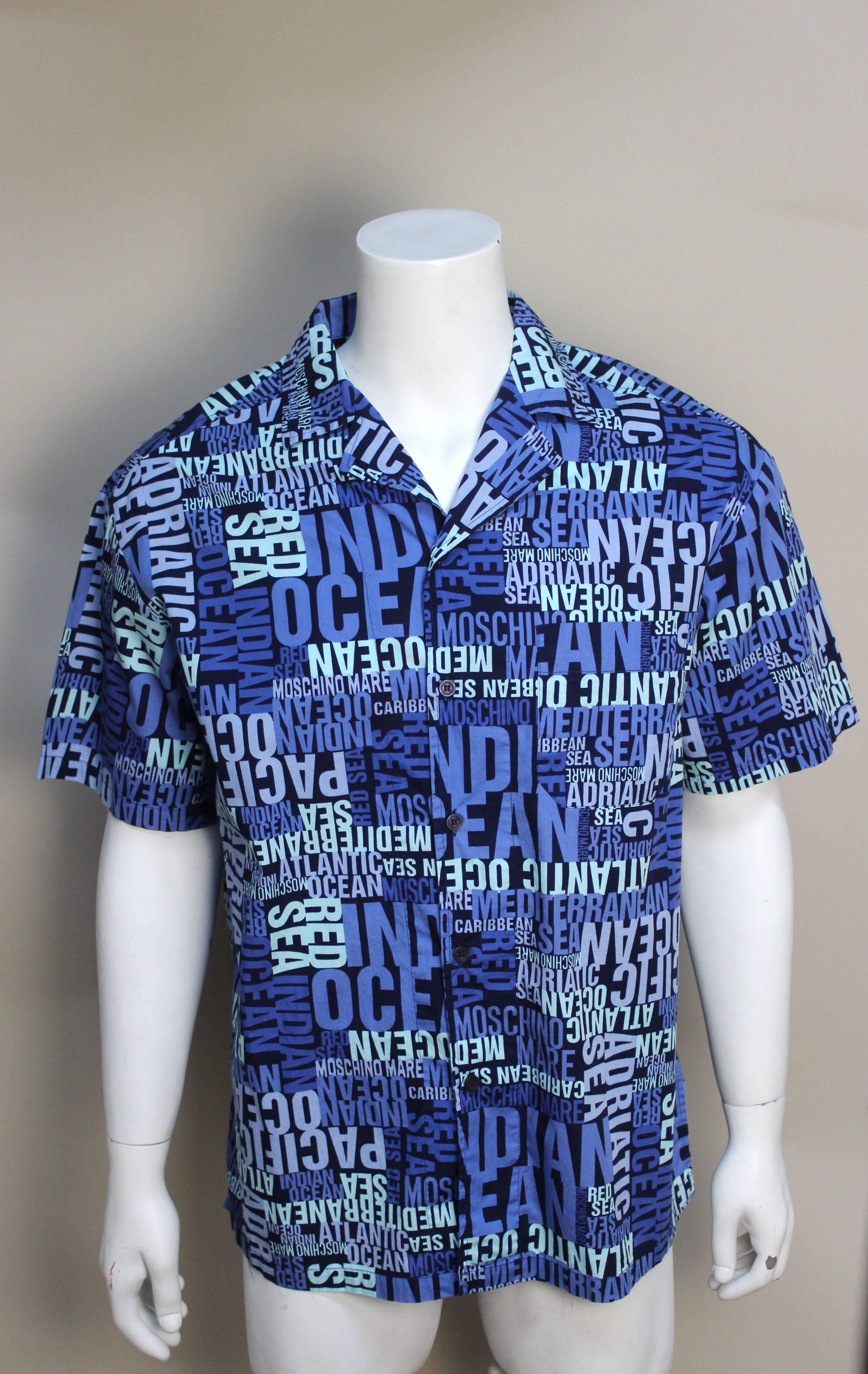 This is the perfect resort shirt. Moschino has spelled out all the world's oceans and lakes in bold lettering in varying shades of blue on a soft cotton navy background.