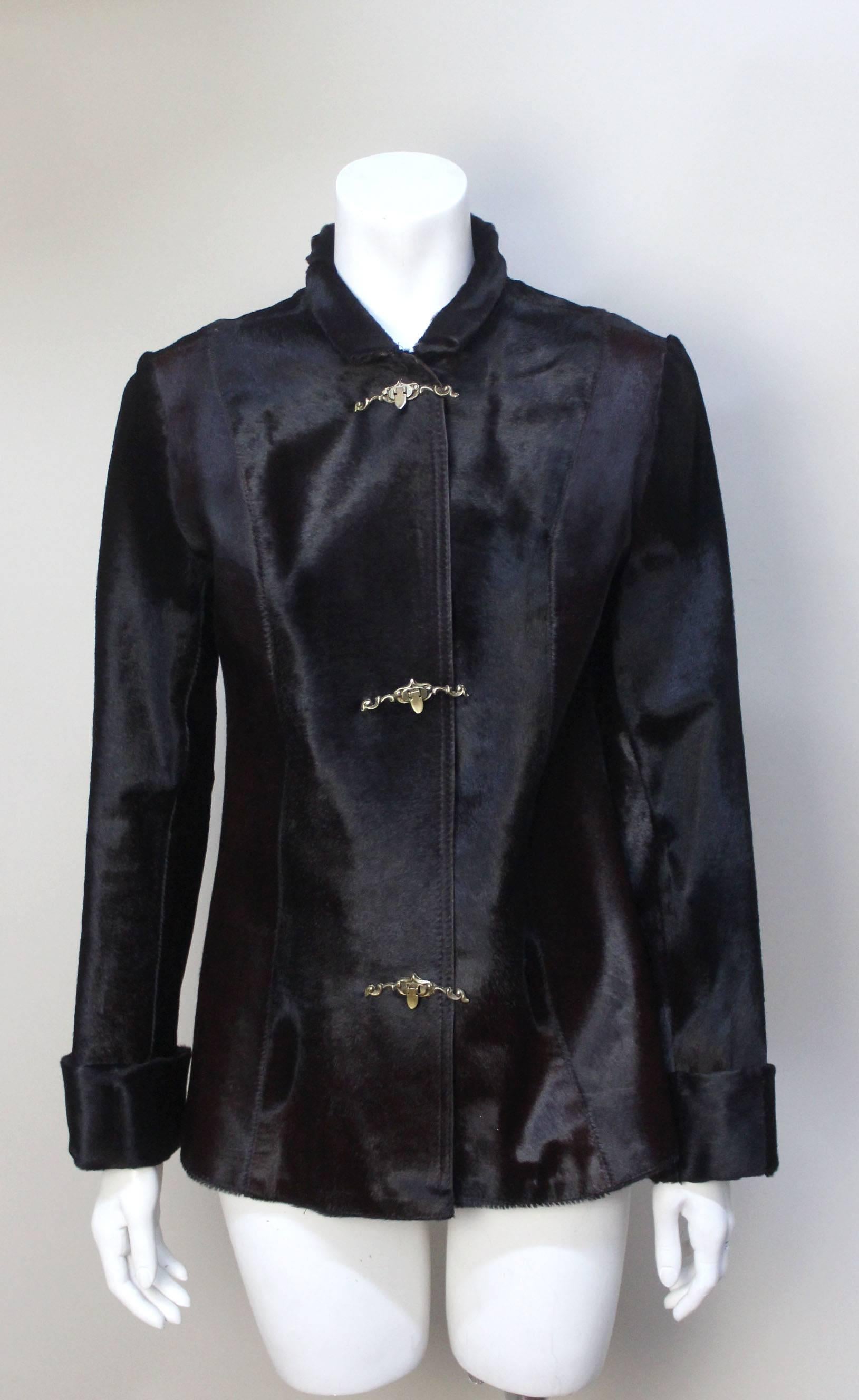 This jacket is a vintage gem. It is a custom made piece with extraordinary detail. The jacket is fitted with long narrow sleeves, wide cuffs, and a high rolled collar. The style is very much what was worn in the Edwardian era. The ponyskin is a