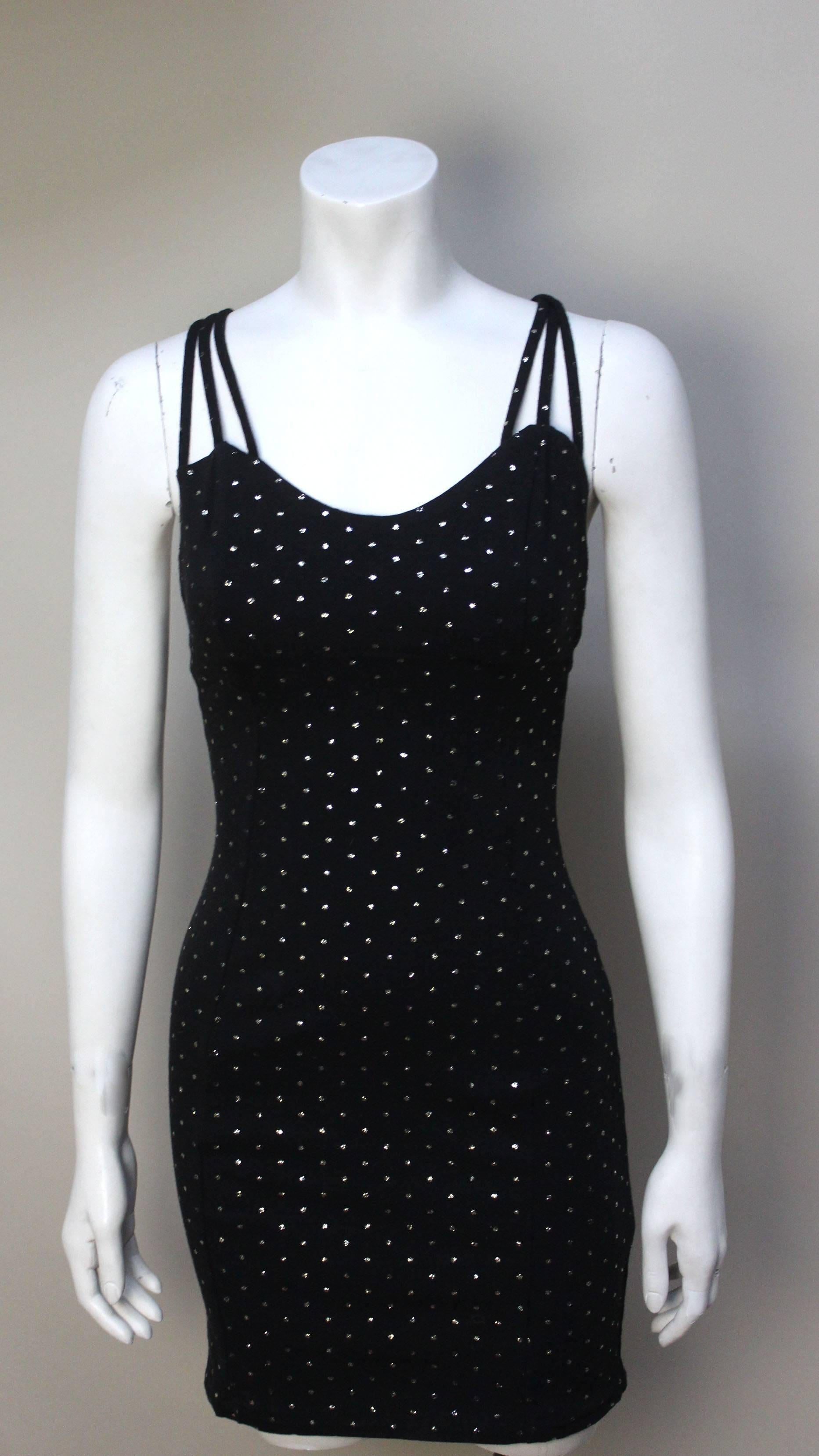 This Betsey Johnson dress dates from her early 1980's punk period, but is as relevant to fashion now as it was then. It hugs the body perfectly and has the  nice detail of triple shoulder straps. The gold glitter dots make it the perfect party