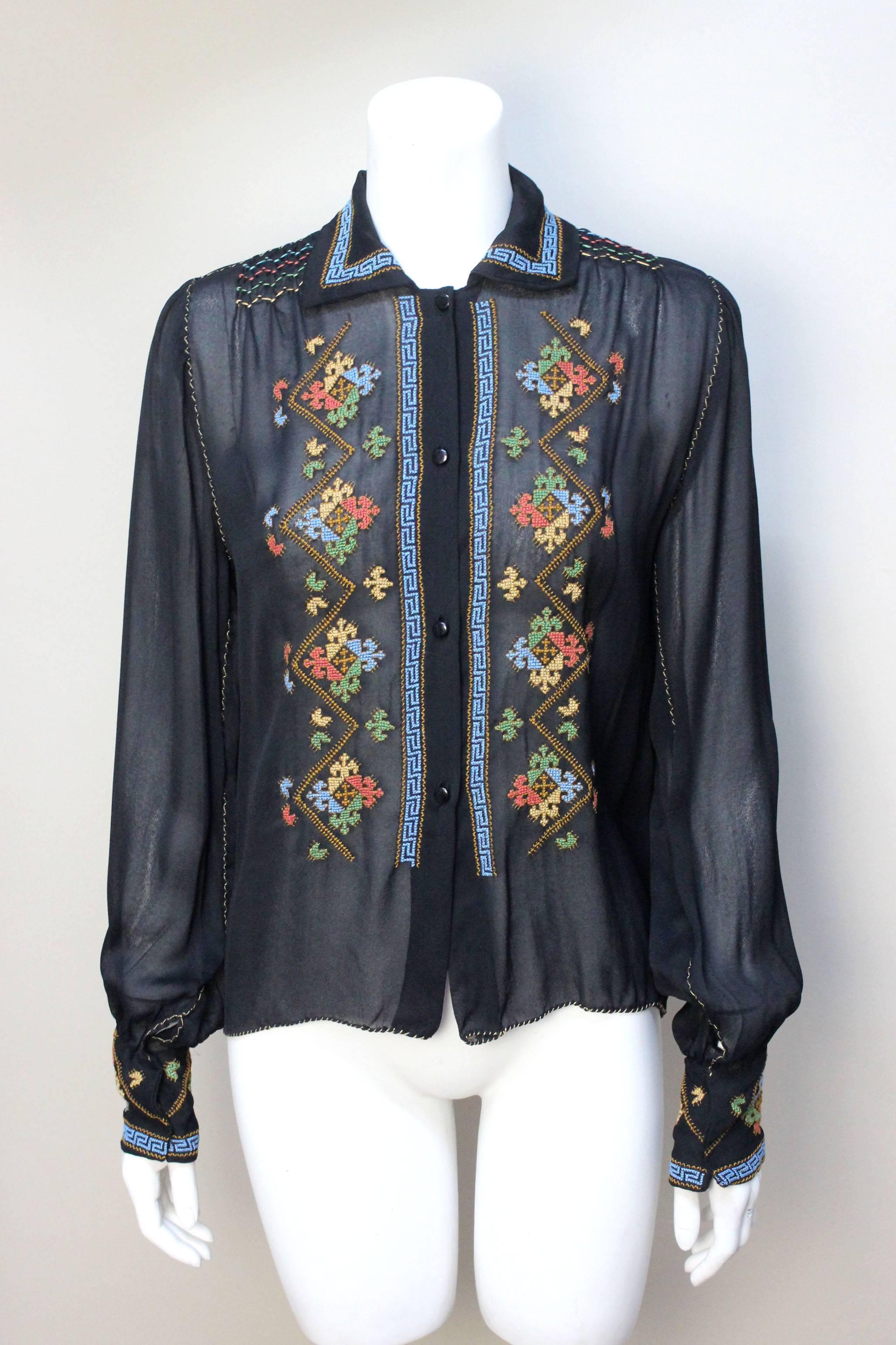 The workmanship on this delicately hand embroidered blouse is beautiful. The style and embroidered motifs suggest a date from the late 1920's to early 1930's, most likely from Greece. The details are exquisite from the multi-colored smocking at the