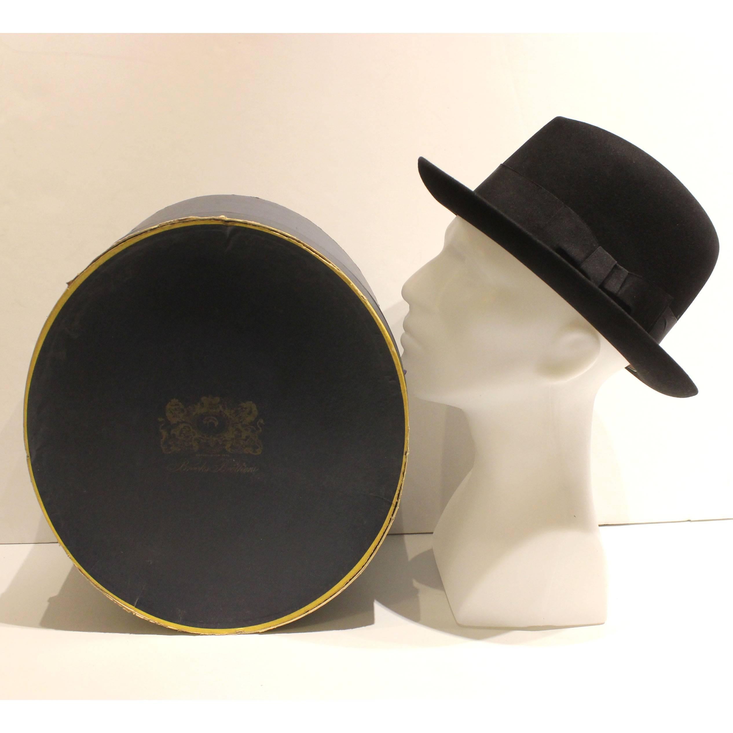 This 40's style black fedora with a black ribbon is made by Lock & Co Hatters, one of the oldest hat stores in the world. Lock & Co Hatters, St. James Street London was established in 1759. The brim is 2.55