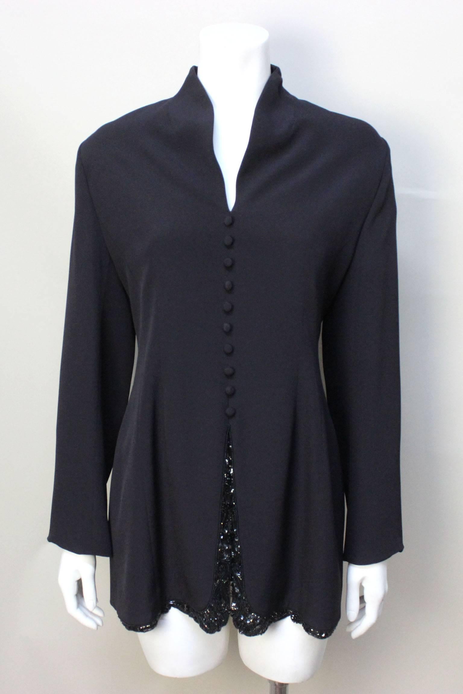 This elegant tunic was sold in the designer penthouse of the upscale Miss Jackson's in Tulsa. The jacket drapes beautifully with a slightly flared bottom. The jacket has ten covered buttons down the front as well as a slit adorned with delicate
