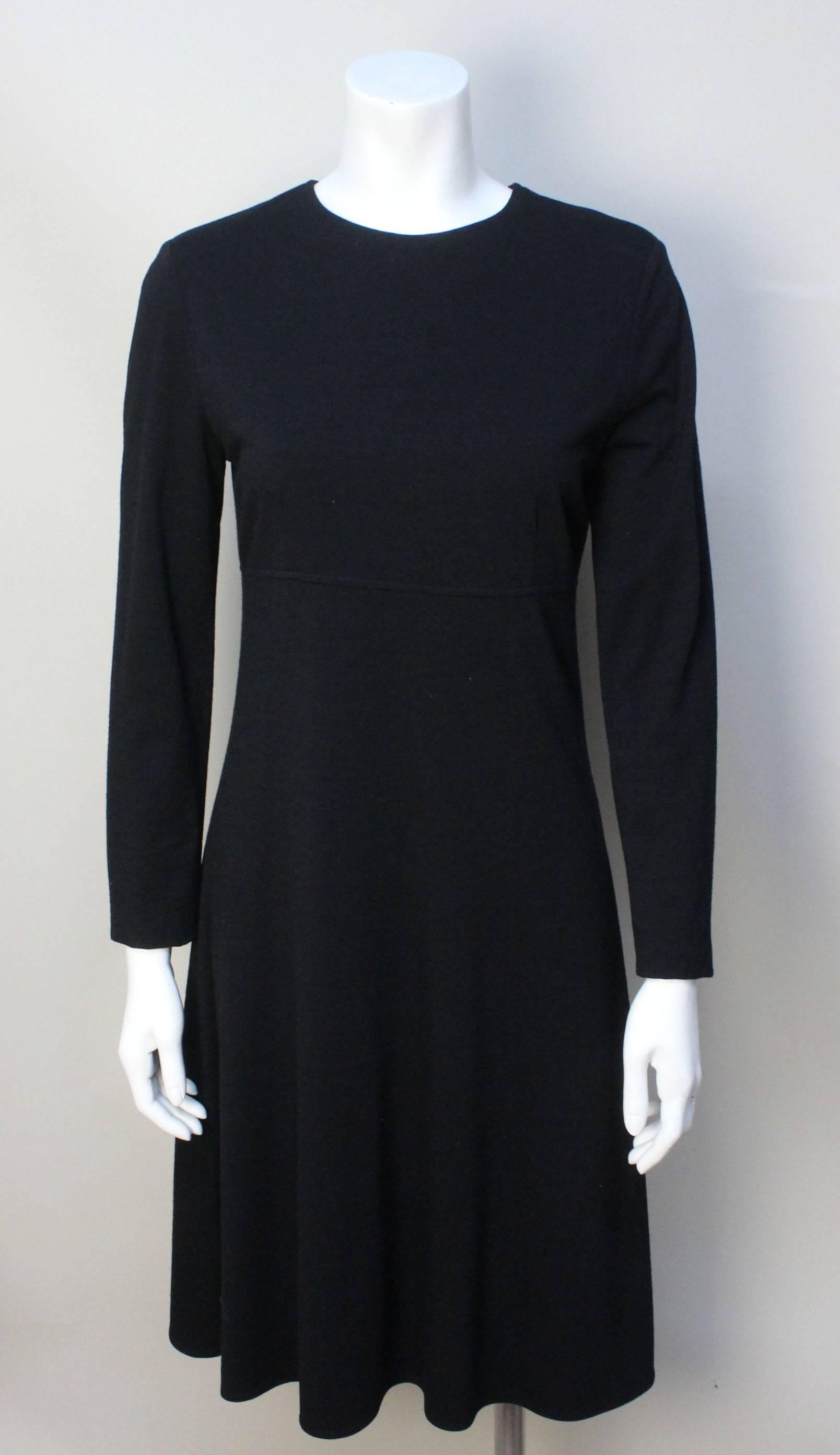 This Calvin Klein dress is simple and elegant. The classic lines make it a versatile dress for day or evening. The fabric is a fine wool that drapes beautifully on the body. It is lined in a silk chiffon. It was originally sold in the penthouse shop