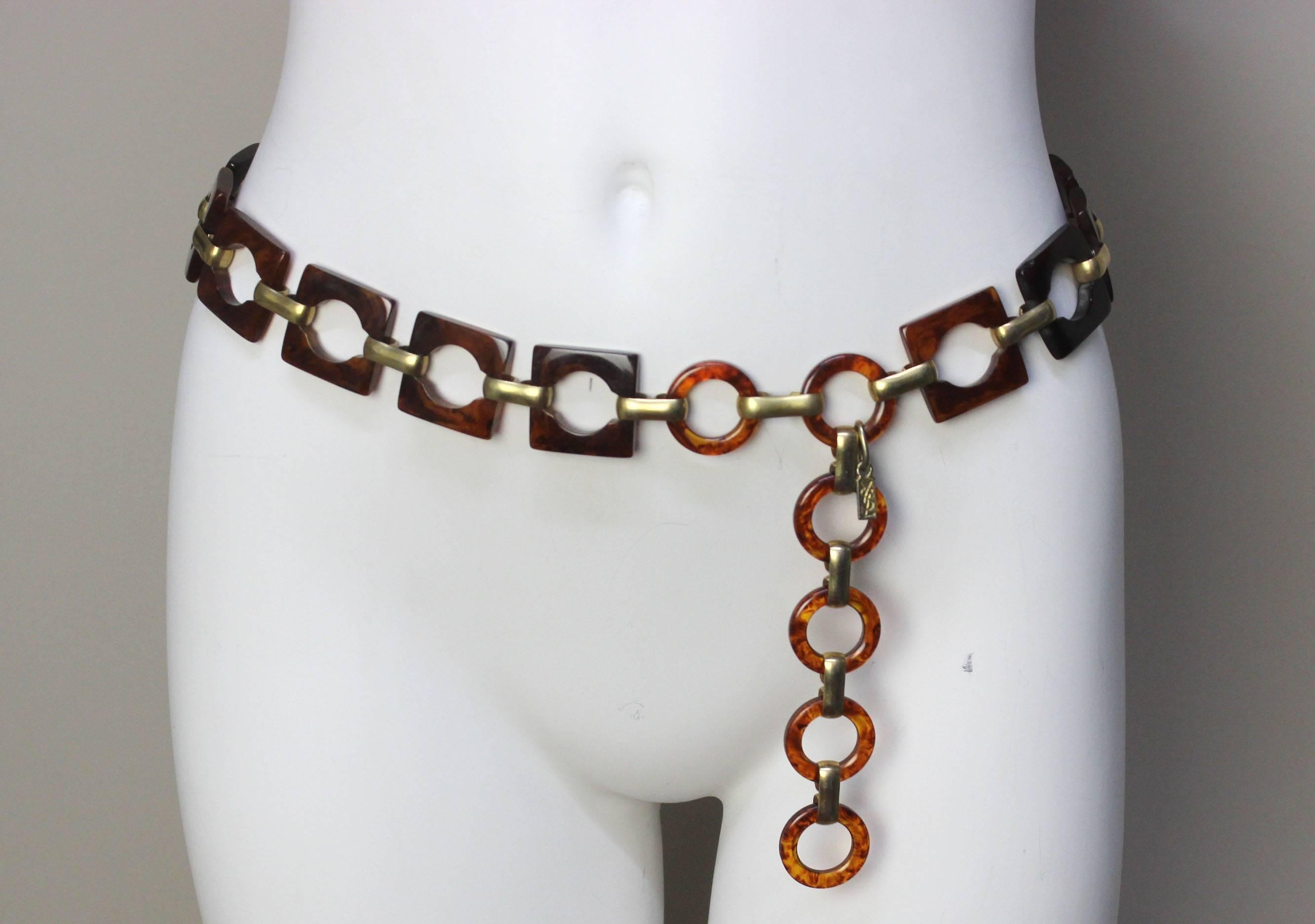 This piece can be worn either as a statement necklace or slung on the waist or hips as a belt. The square links have cut out circles connected by brass links. At either end are round links, adding to the geometric design. The links have a