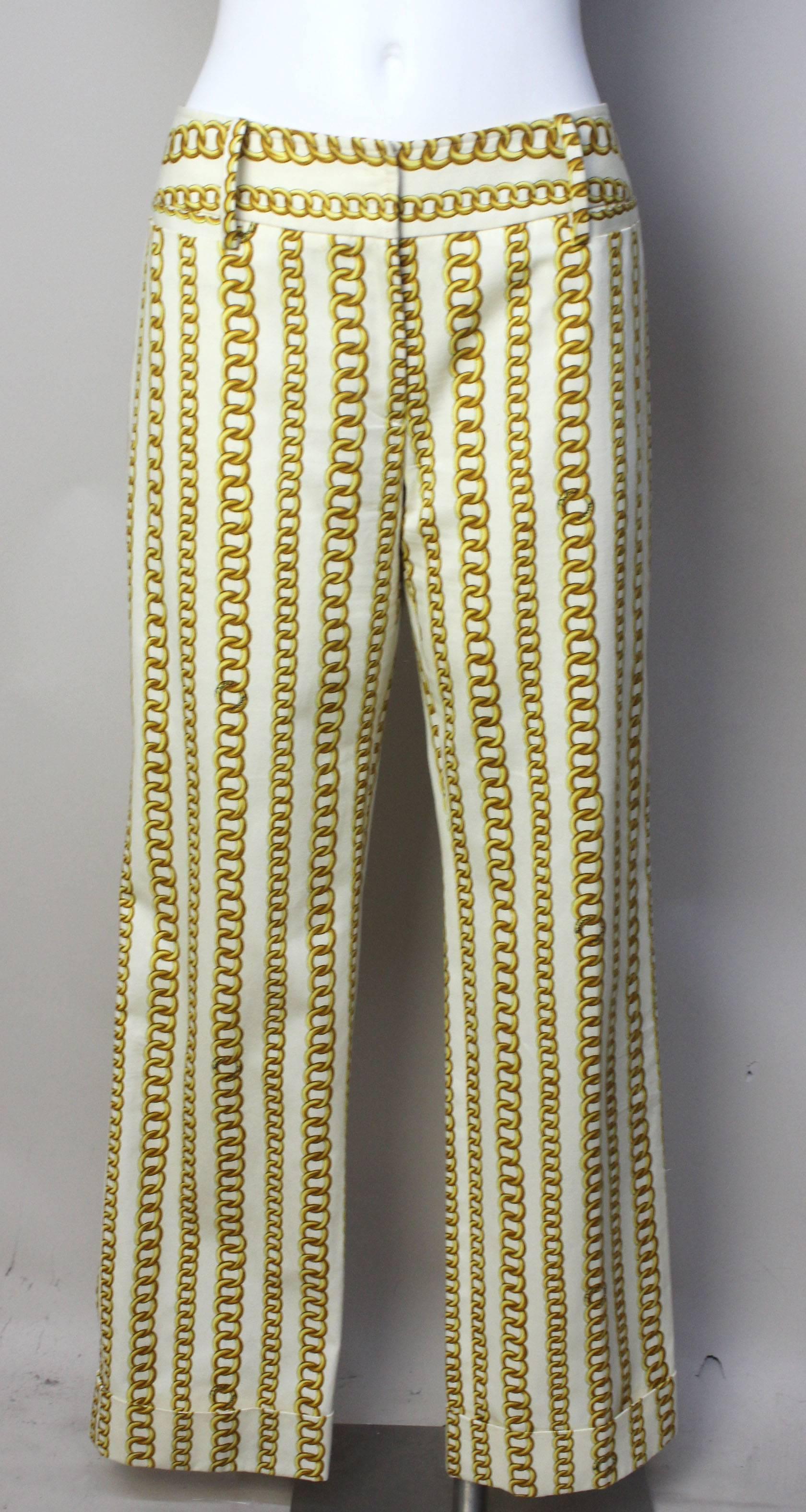 The pattern on these pants are whimsical like so many of Dolce/Gabbana's designs. It has bold trompe l'oiel vertical gold chains with the designers signature incorporated in the links. The fit is slightly low rise with wide belt loops. The pants