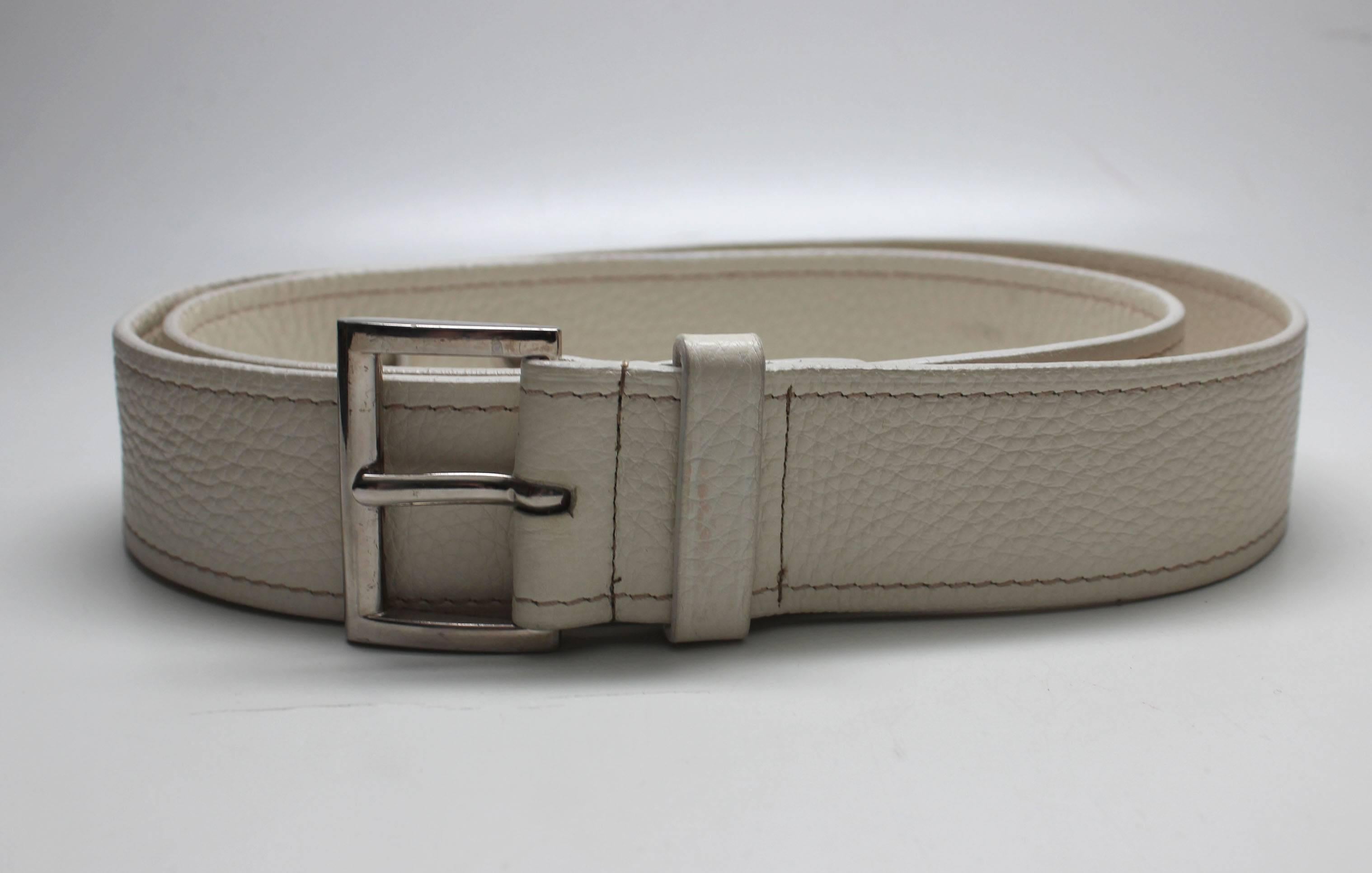 This fine leather belt is in a perfect creme color that is hard to find in mens accessories. The styling is simple but elegant with a silver tone buckle and tan contrasting stitching along its edges. There is also a nice stitched detail at its end. 