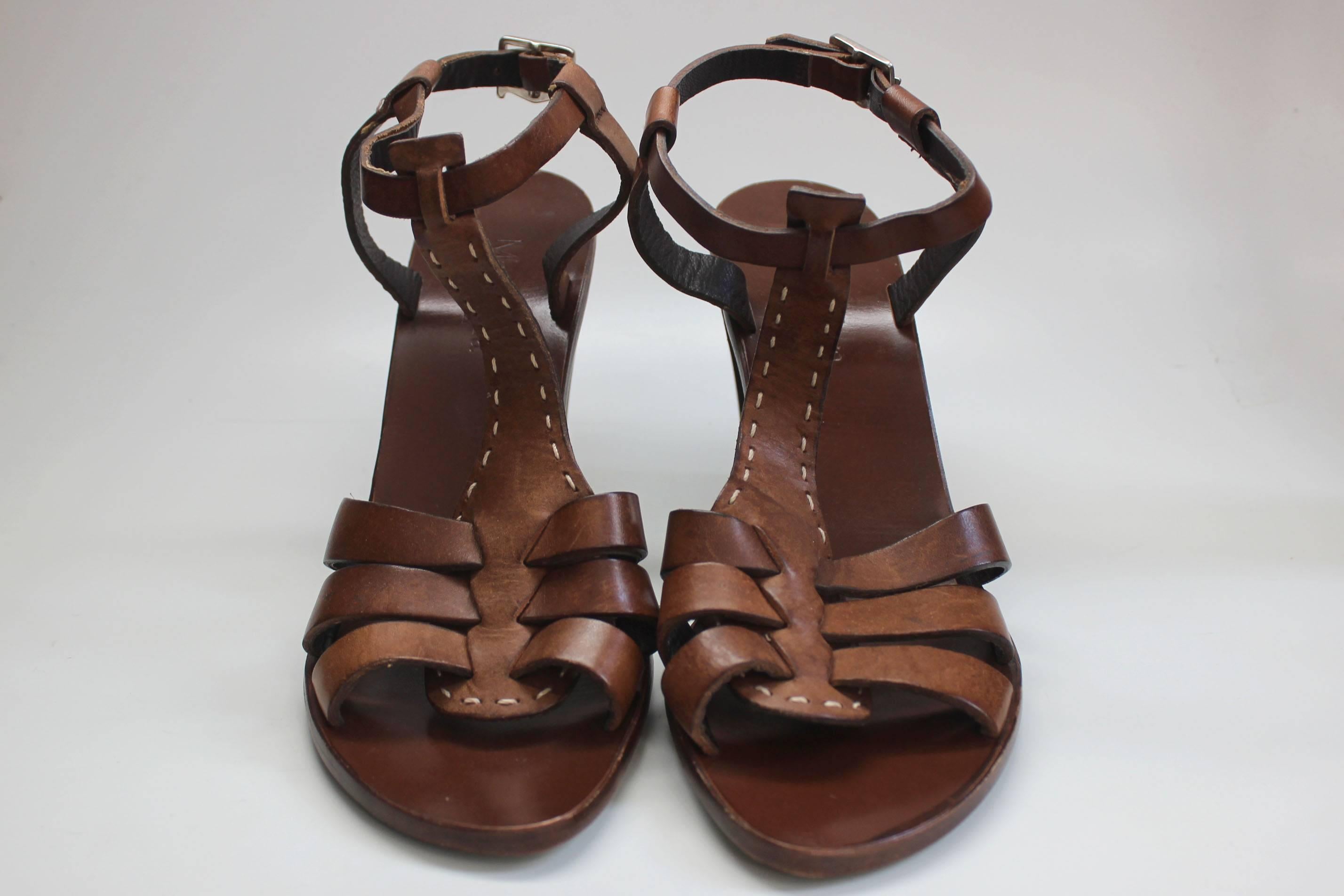 These leather sandals by Max Mara have three straps of brown saddle leather across the toes. The tee strap is stitched with a creme border, and it has a 4 inch heel.