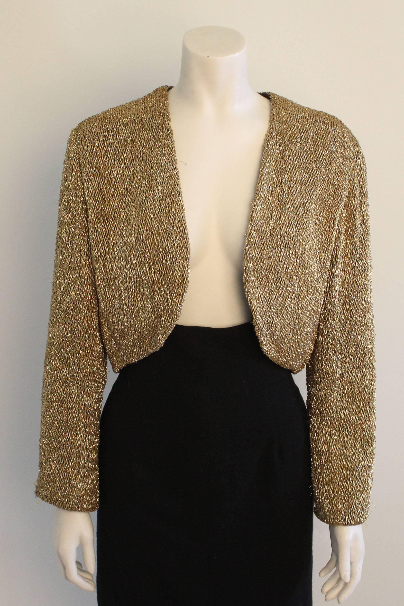 This outstanding jacket by Anne Klein is constructed from twisted metallic thread that gives the effect of an overall beaded surface. It is lined in 100% silk. 