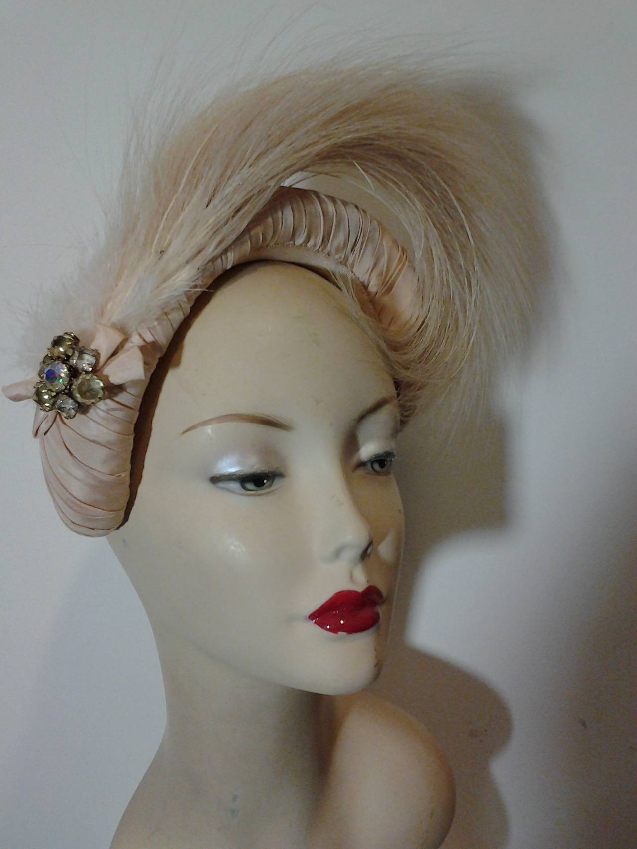 A superb 1950s Simone Geist egret feather, ballet-inspired headband hat. Made in France of pale pink silk satin and egret feathers.  Reminiscent of a Swan Lake headpiece.