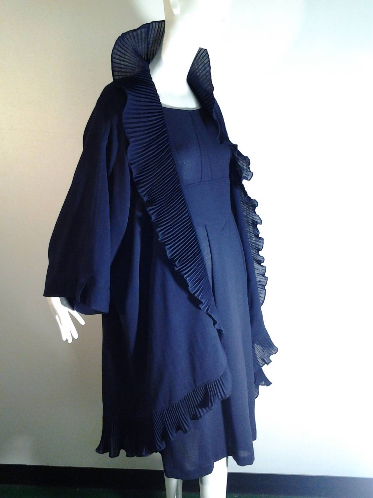 A gorgeous 1990s Jeanne Muir lightweight navy crepe dress and cocoon coat ensemble:  

Jacket is a kimono-cocoon hybrid style with pleated bias ruffle at neckline and silk lined.  

Dress has side hidden pockets, epaulet style sleeve gathers and