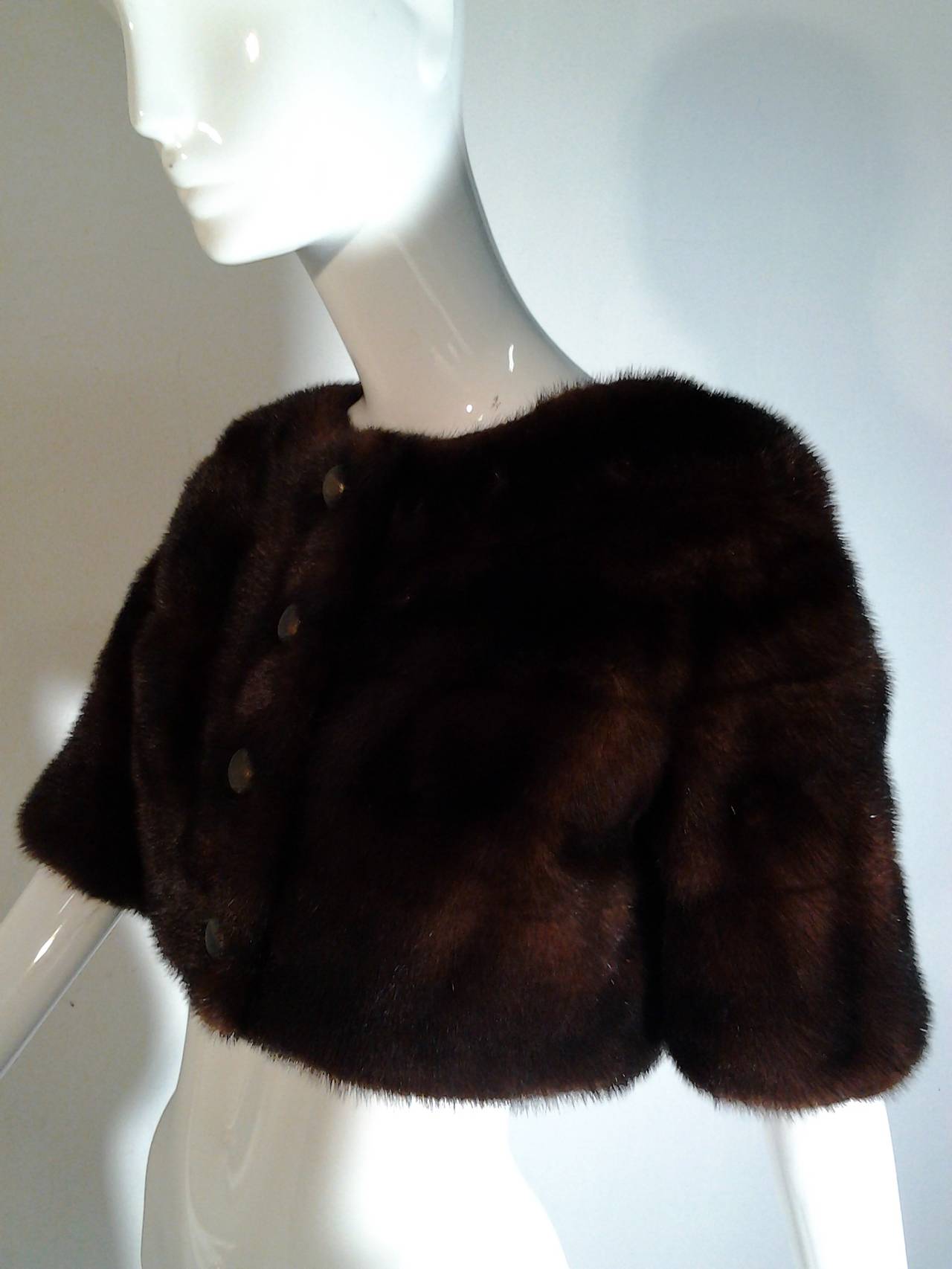 A beautiful Mod 1960s Bergdorf Goodman chocolate brown mink cropped bolero jacket lined in matching silk with original buttons.