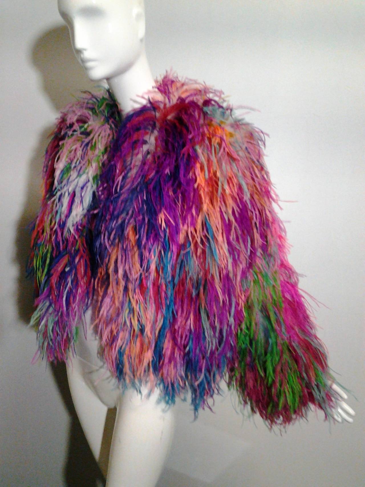 A terrific 1980s Adrienne Landau ostrich feather chubby jacket in spectacular multi-color palette. Fully lined in satin with hook and eye closure.