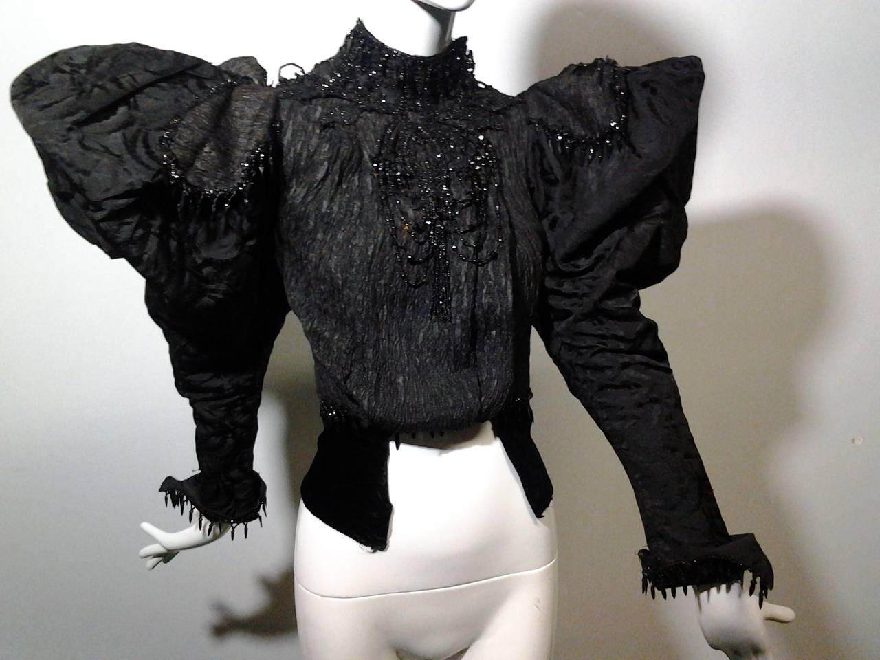 An incredible, structured Victorian blouse:  Stays in bodice, unusually large leg-o-mutton sleeves embellished with jet beaded epaulets and heavily beaded front section.