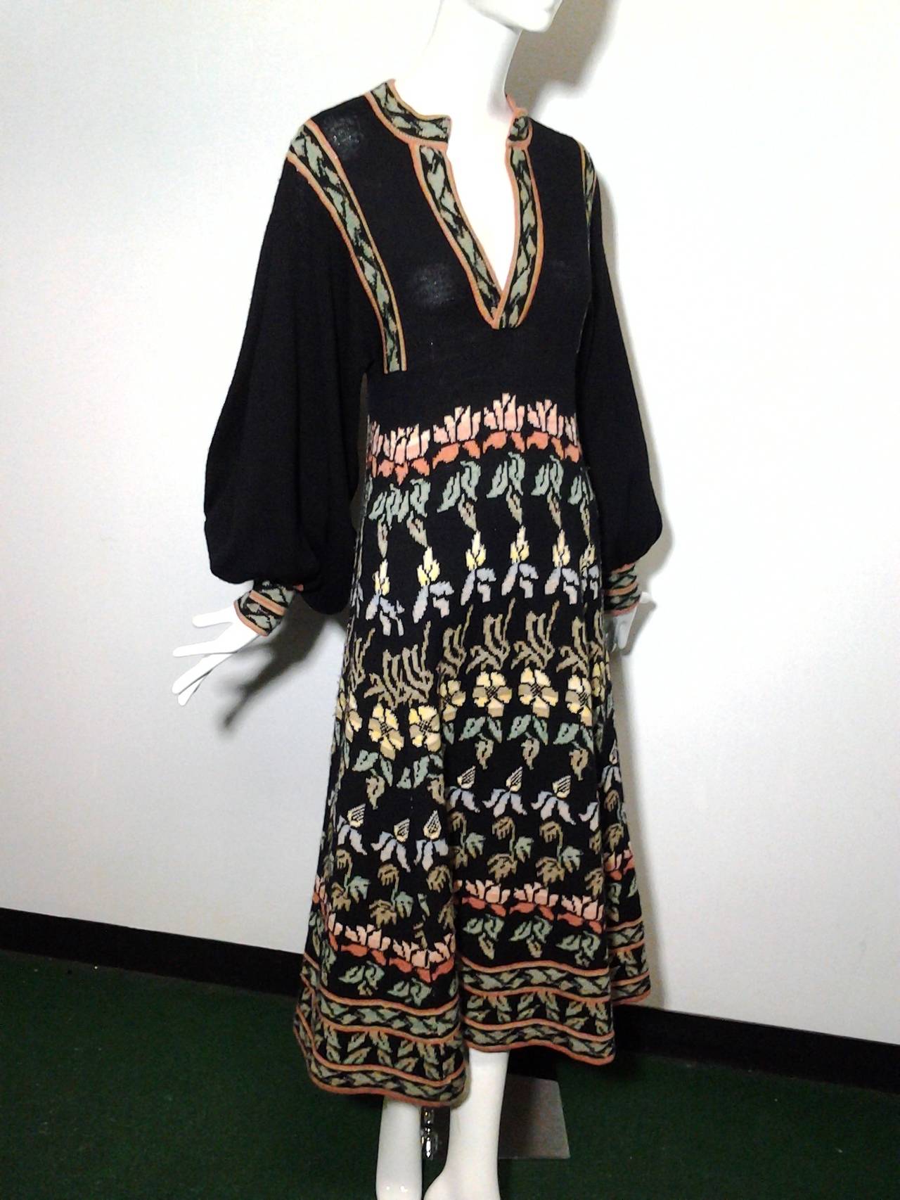 A gorgeous 1970s Bohemian wool intarsia knit midi length dress with Nehru collar and deep plunging neckline.  Balloon cuffed sleeves.