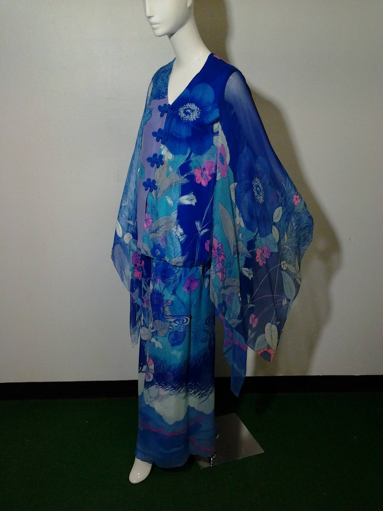 This evening ensemble is an early example of Hanae Mori's work. Here she uses two types of fabric printed with the same motif to create a shadow effect. The cape sleeves are reminiscent of the extended sleeves of the furisode, a formal kimono style