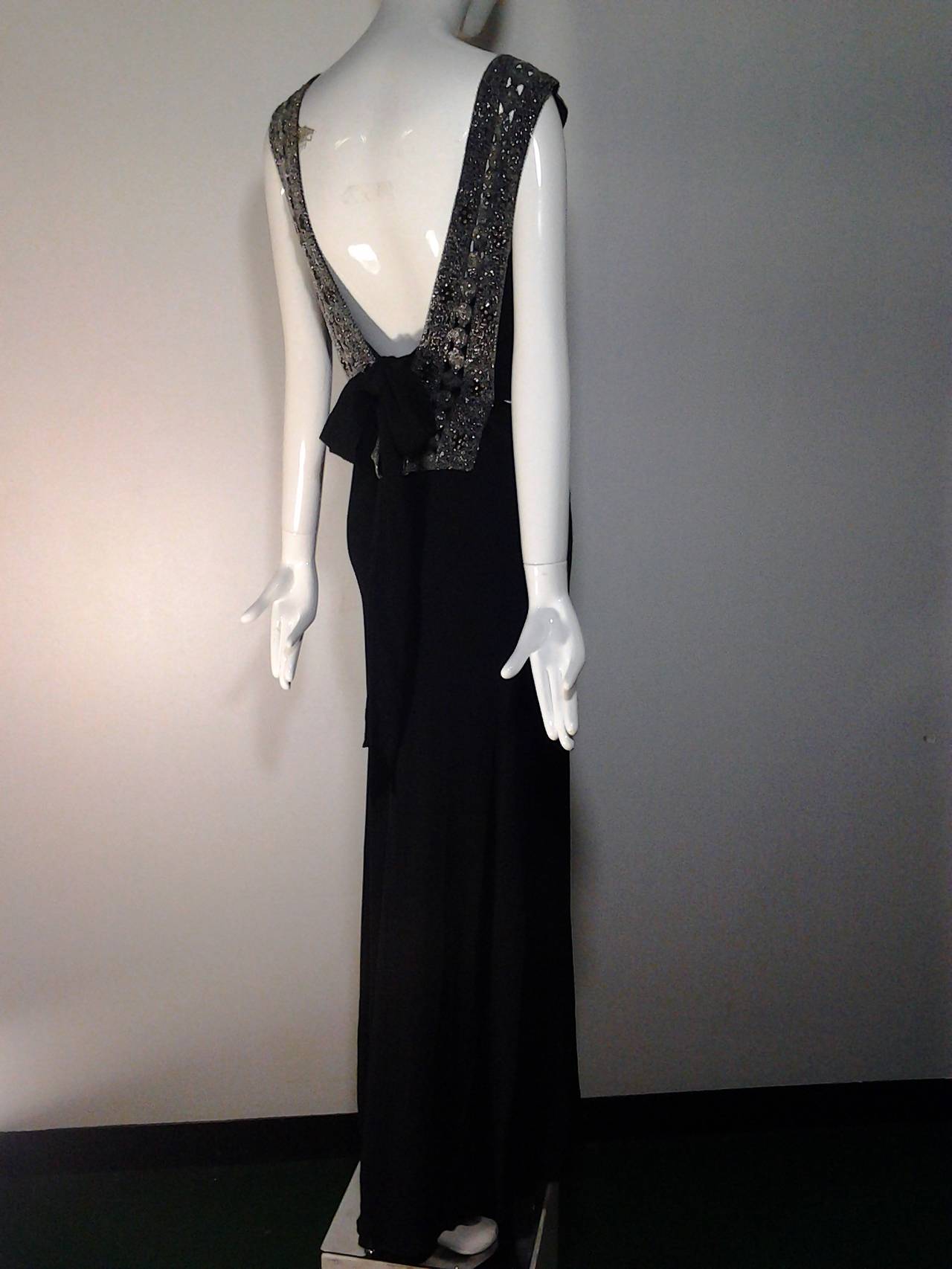 A gorgeous 1930s French evening gown:

 Bias cut silk crepe with low cut armholes and sexy low back.  Heavily beaded tapered panels drape from front waist, over shoulder, to a wide square cut back 