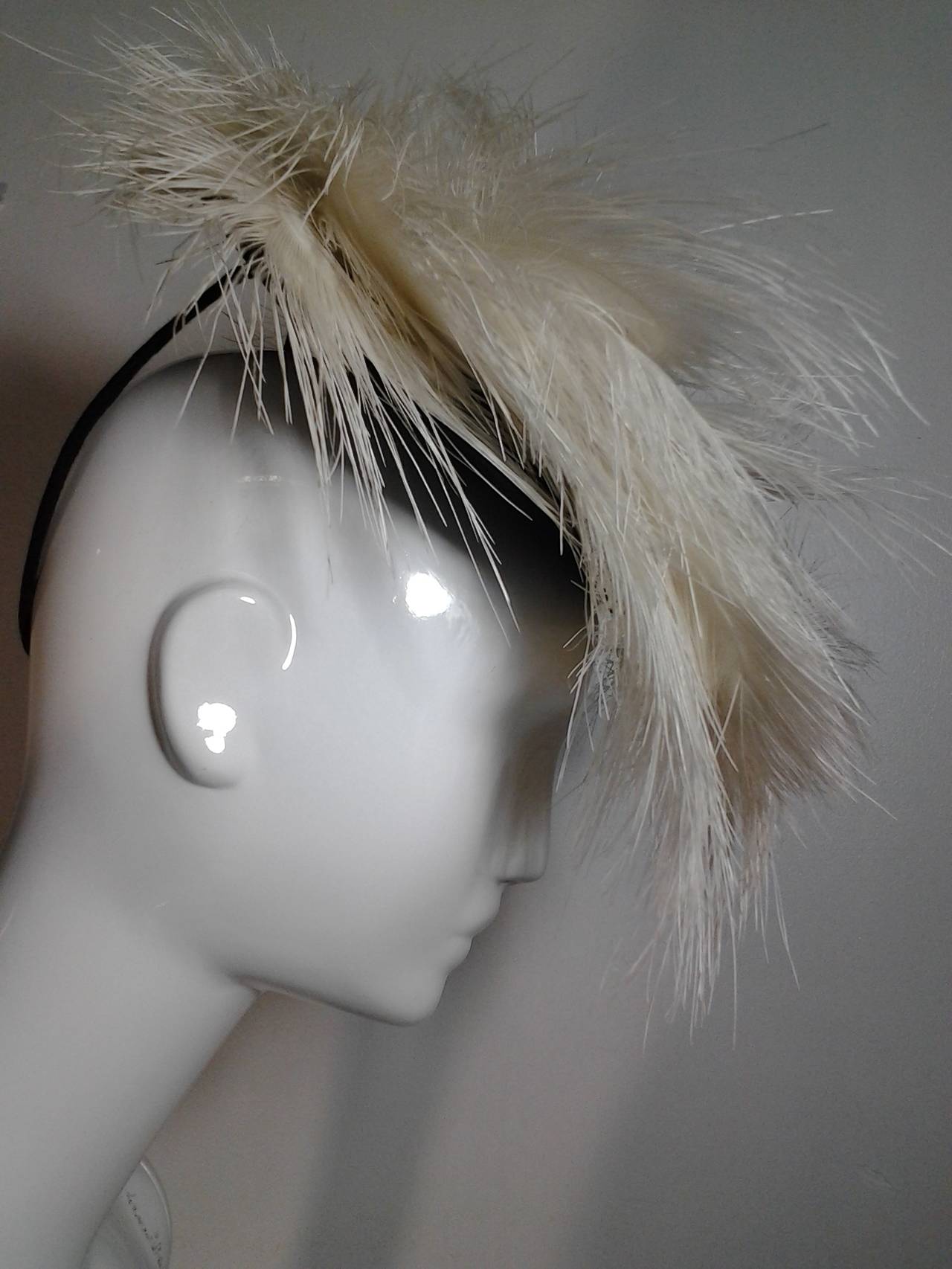 A fantastic and dramatic Barbara Charles 1940s tilt hat of black felt and off-white egret feathers.  Back loop of felt and wire to secure to head.  One Size