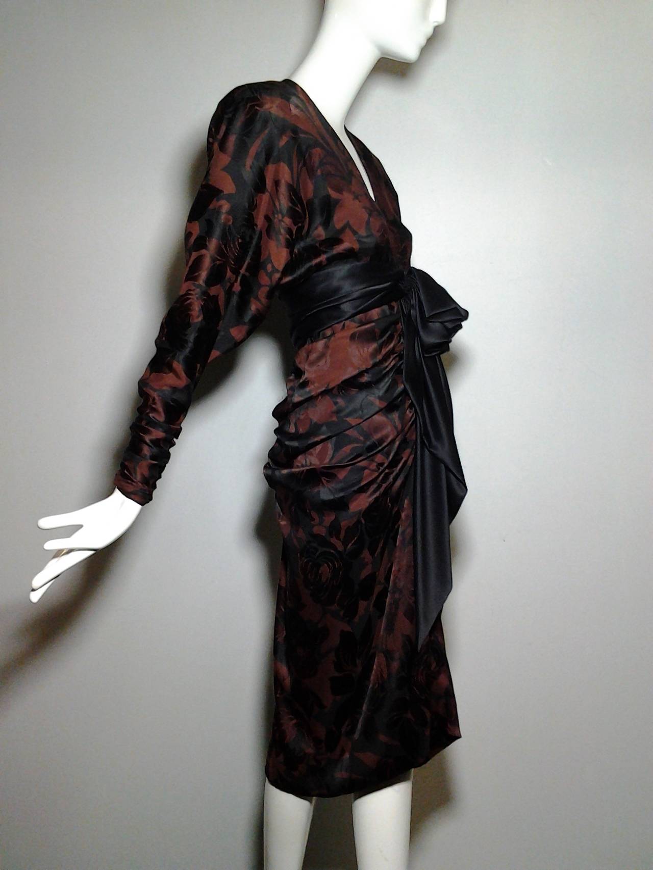 A sexy and beautiful 1980s James Galanos black and espresso floral print jacquard dress. Plunging wrap neckline with ruched front and back of skirt.  Wide obi-inspired waist sash.  Completely lined in charmeuse.
