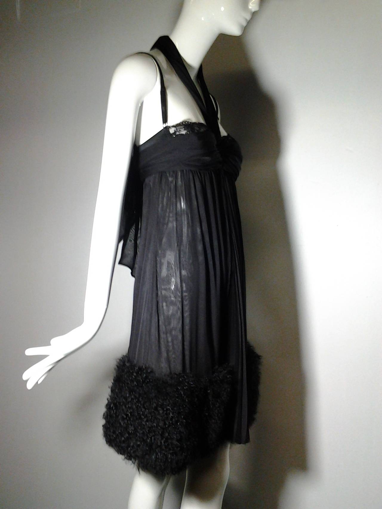 A super sexy D&G black silk chiffon babydoll negligee style cocktail dress with dramatic, soft Mongolian lamb hem and iconic Dolce and Gabbana attached peek-a-boo brassiere.

Never worn.