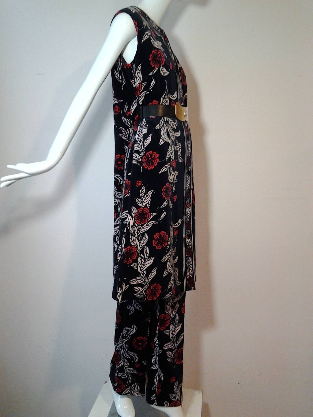 1970s Emilio Pucci black, red and pink velveteen floral print pant and vest ensemble:  High-waisted straight-leg slim pants, and maxi vest with side belt holes and deep side vents.  Covered button closures on vest. Fully lined. 

Styled and sold