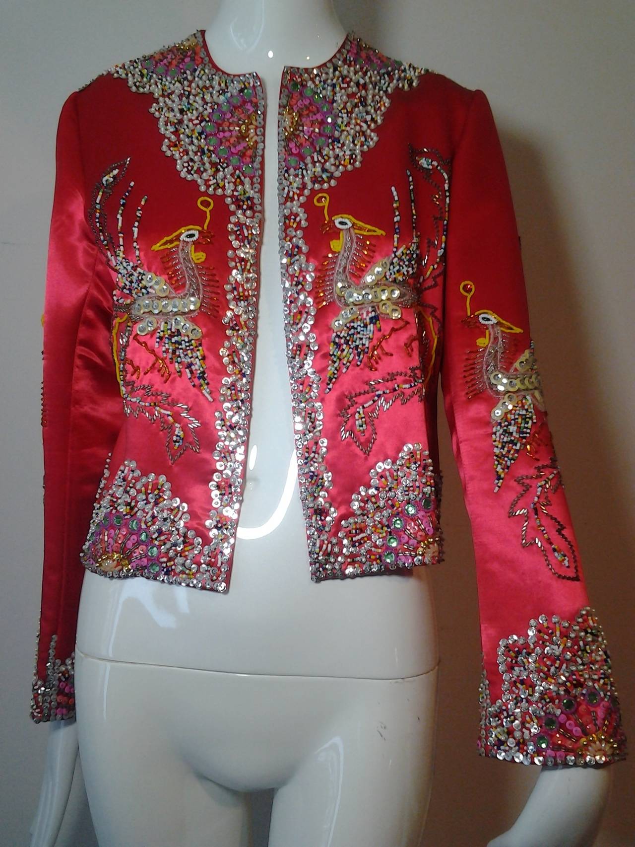 A wonderful Dynasty 1960s silk satin Hong Kong beaded and sequined Phoenix Bird jacket.  Firecraker style beading.  Silk lined. No closure or collar.