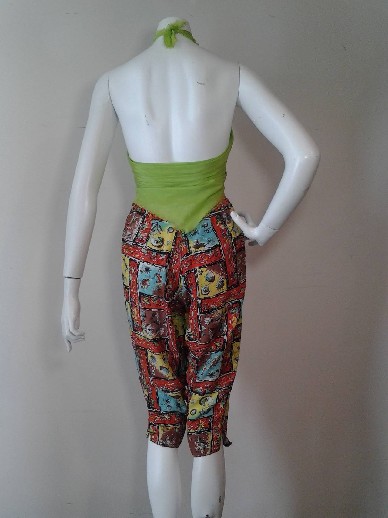 Adorable 1950s washed silk capri pants w/ sea shell motif print.  High waist with coconut button, back center zip, and side vents at cuffs. 

Pictured with silk scarf as top, included in purchase price.